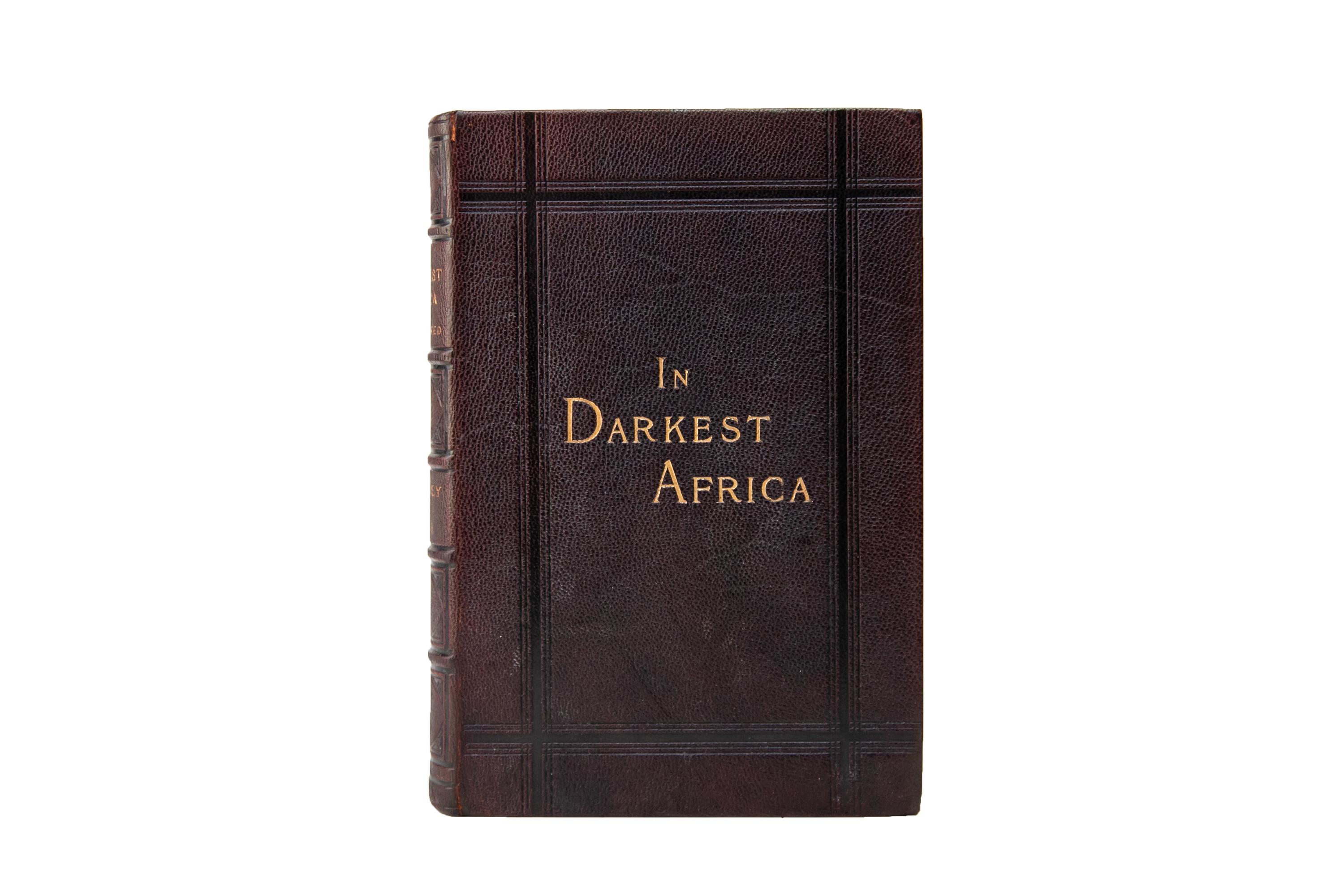 2 Volumes. Henry M. Stanley, In Darkest Africa. Bound in full brown morocco with the covers displaying open-tooled borders and gilt-tooled label lettering. The spines display raised bands, open-tooled panel details, and gilt-tooled label lettering.