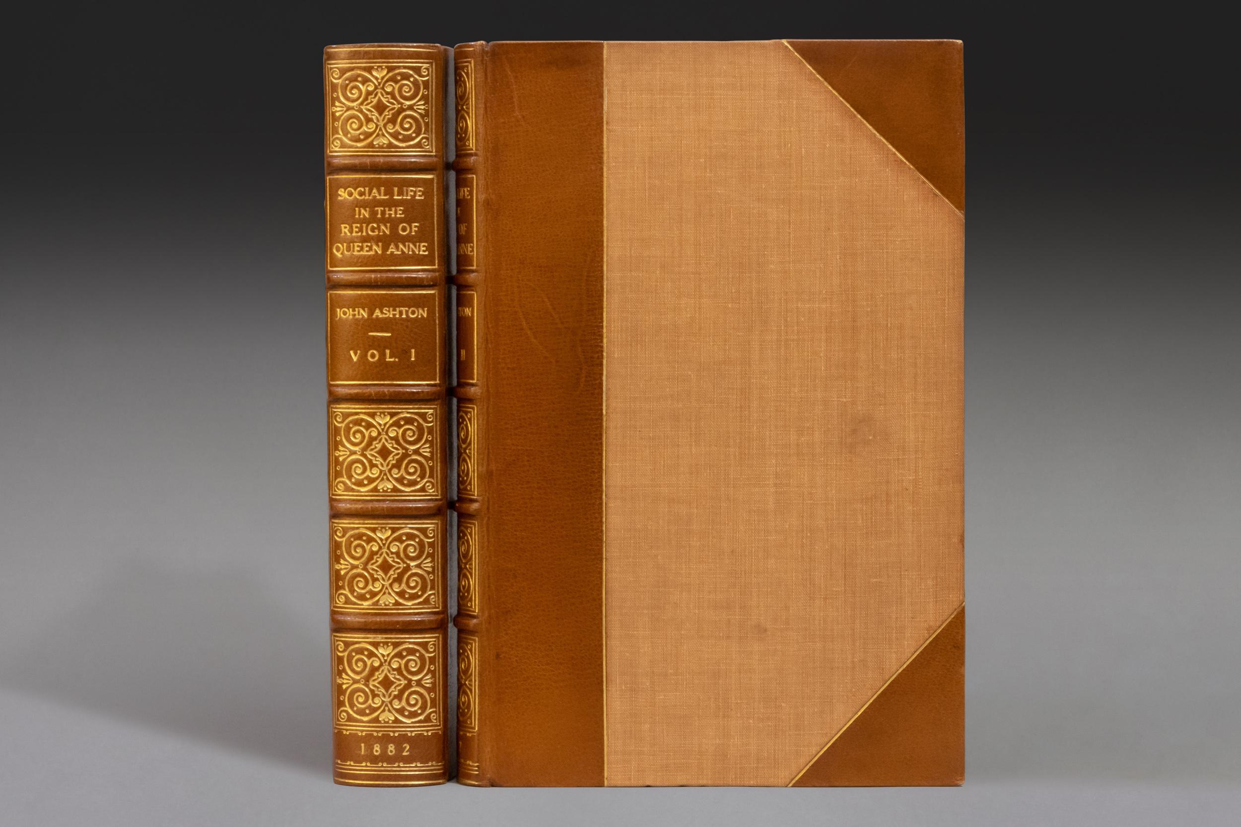 2 Volumes. John Ashton, The Social Life in the Reign of Queen Anne taken from original sources. Bound in 3/4 light brown morocco. Top edges gilt. Spines gilt, by Stikeman. Morocco booklabel and large bookplate of Henry Clay Frick. Published: London: