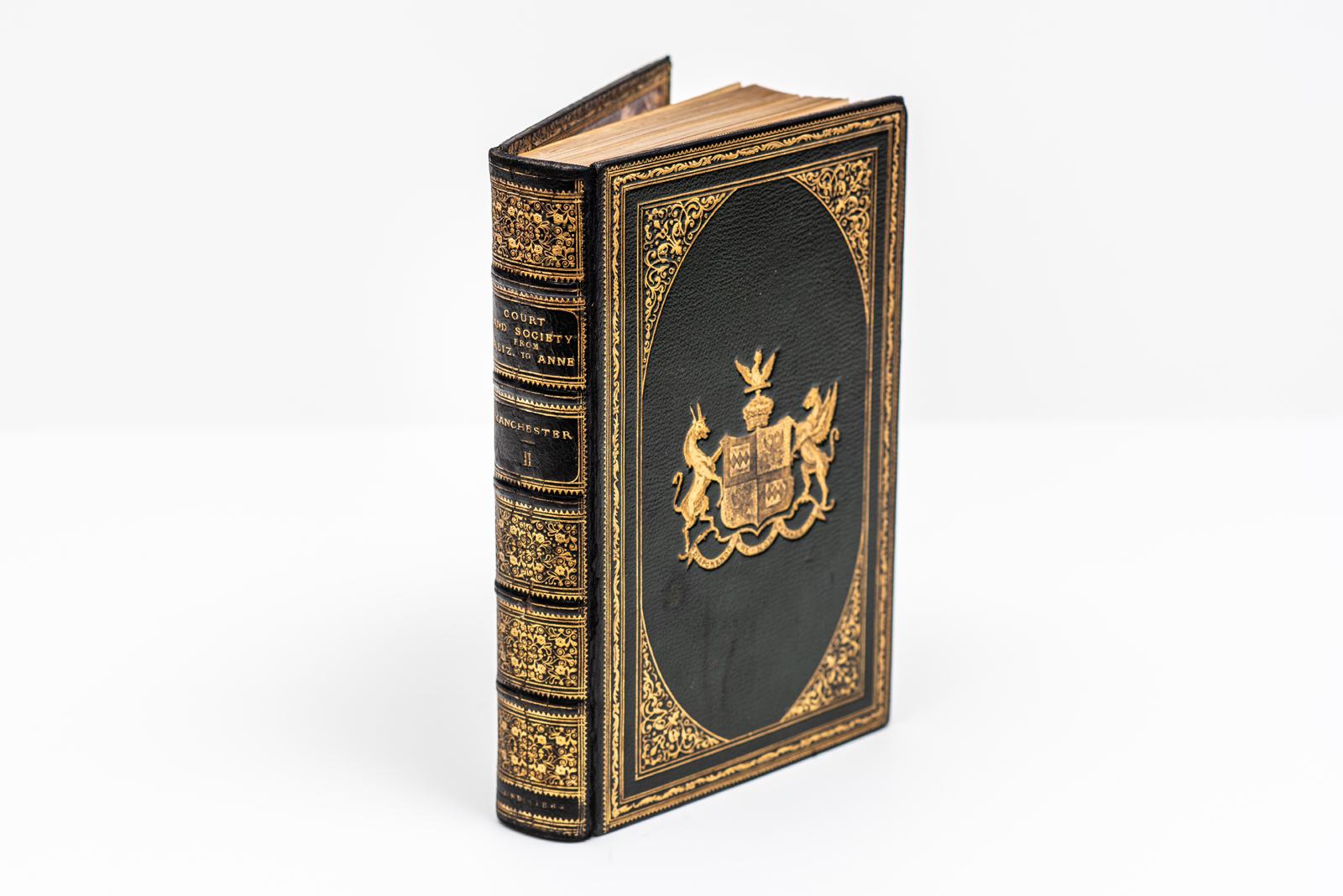 2 Volumes. The Duke of Manchester, Court and Society from Elizabeth to Anne. Bound in full green morocco with the covers and raised band spines displaying ornate gilt-tooled detailing. All of the edges are gilt with gilt-tooled dentelles and marbled