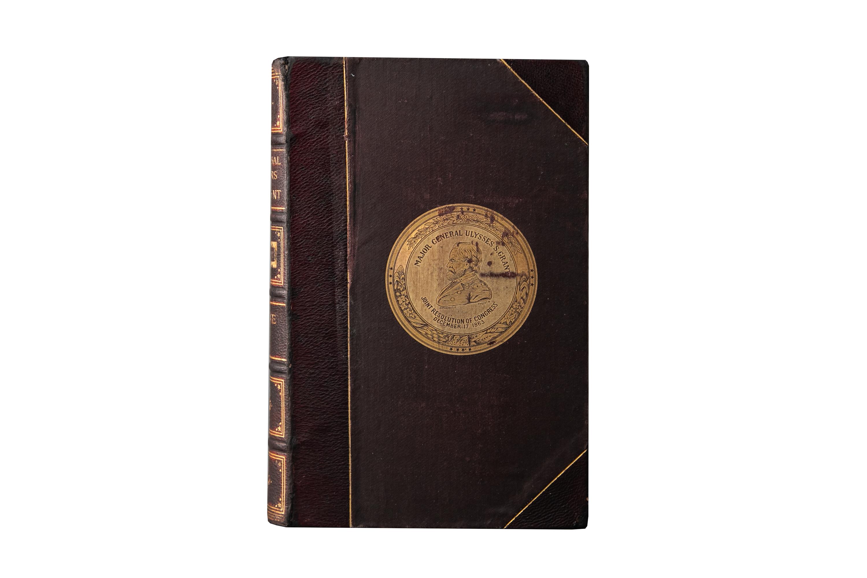 2 Volumes. U.S. Grant, Personal Memoirs. First Edition. Bound in 3/4 brown morocco and linen boards with a gilt-tooled seal on the cover. The spines display raised bands, Americana details, and label lettering, all gilt-tooled. All of the edges are