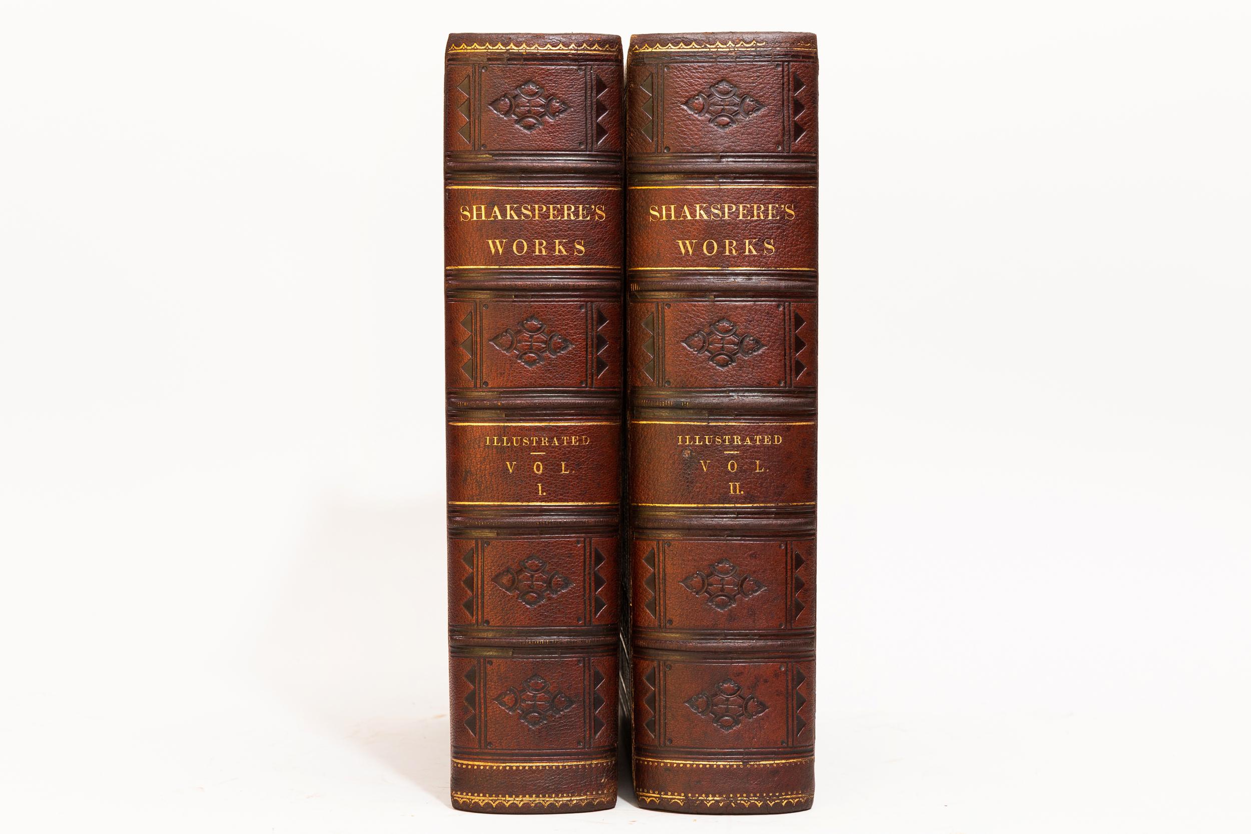 2 Volumes. William Shakespeare, The Works of Shakespeare. Bound in full brown morocco. Decorative blind tooling on covers. Decorative gilt emblem of Shakespeare on covers. Raised bands. Decorative blind tooling on spines. All edges gilt. Silk