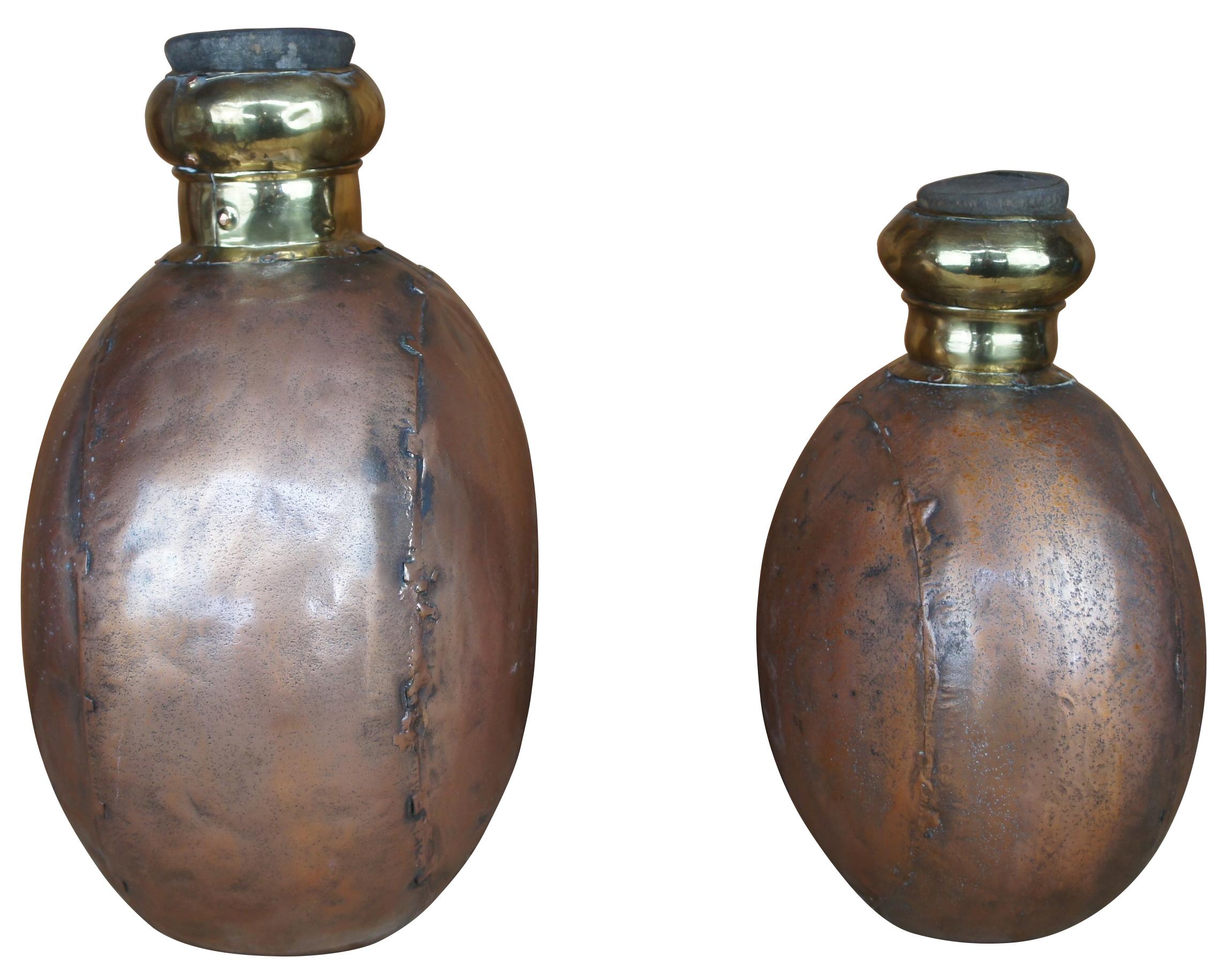 Two large vintage copper canister jugs, bottles or vases featuring cork stopper and dovetailed accents. From India.

Larger - 12
