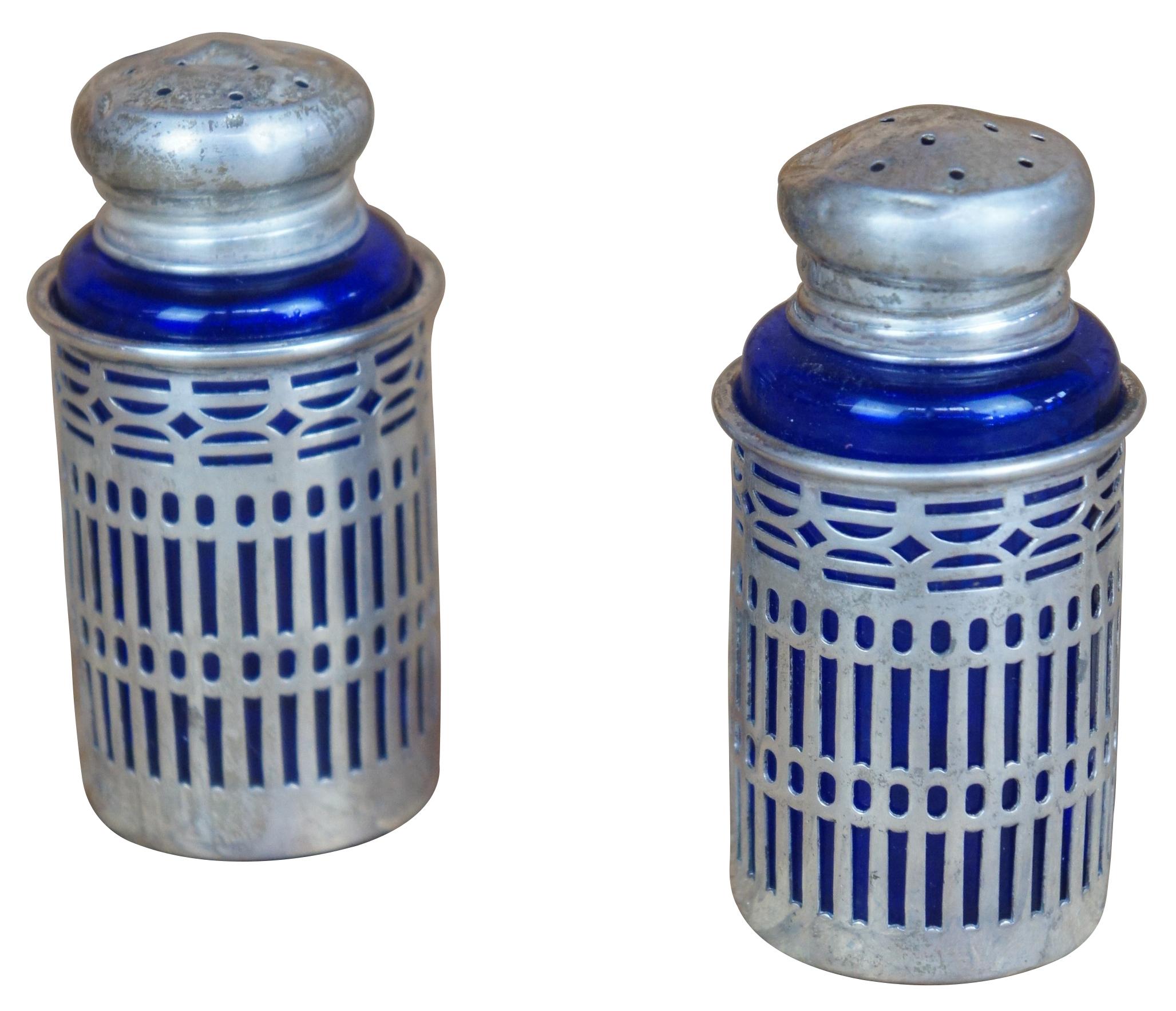 Two vintage Webster sterling silver 925 salt and pepper shakers featuring pierced / reticulated / filigree design with cobalt blue glass inserts.
     