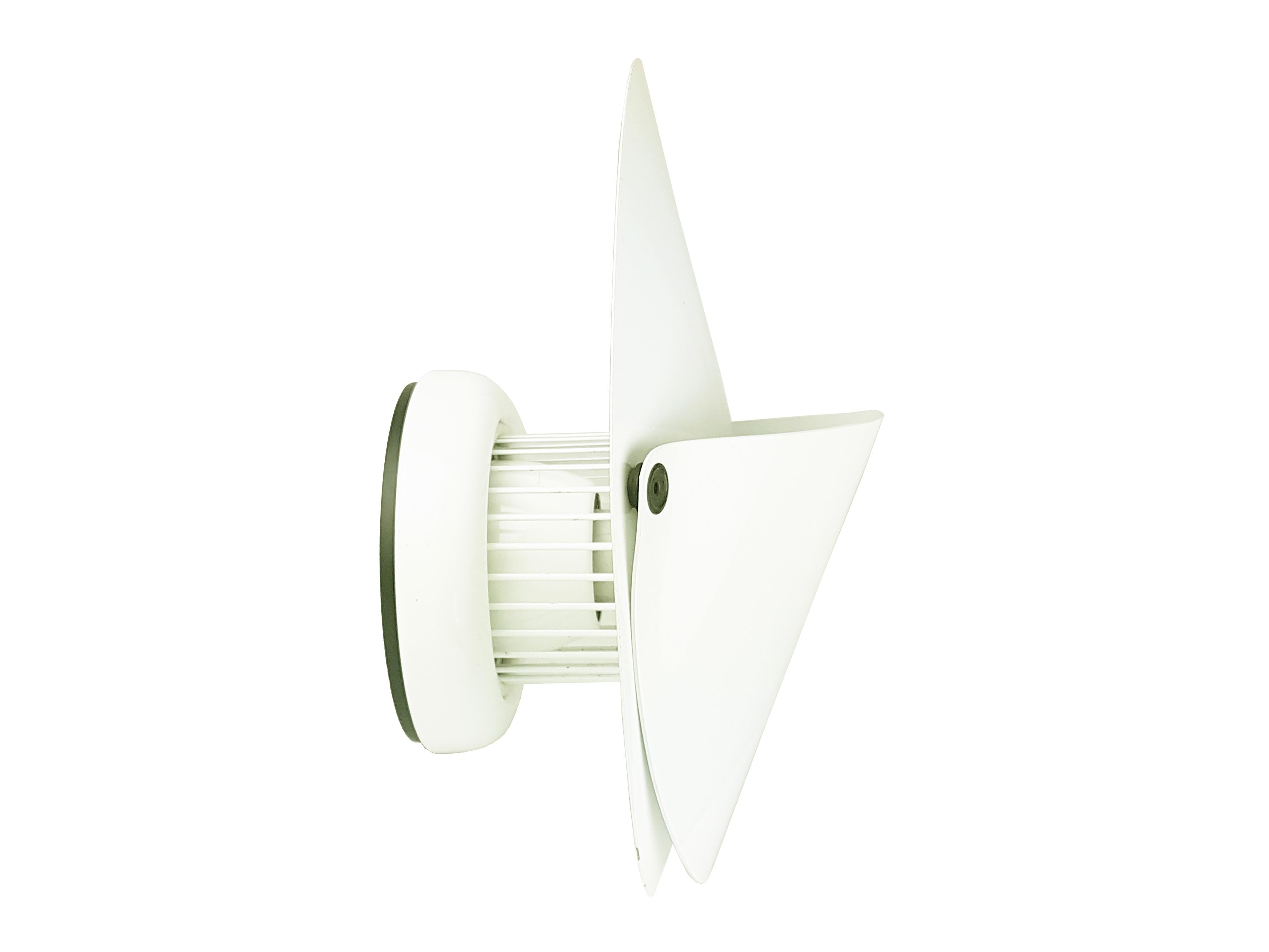 Pair of wall lamps mod. Giovi, designed by Achille Castiglioni in 1976 and produced by Flos. White metal & aluminum structure with rubber stop. The front lampshade is applied to the main body of the lamp through 2 snaps.
This lamp, once turned on,