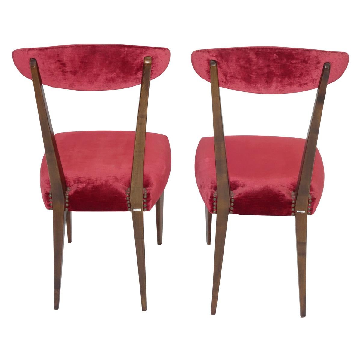 2 elegant side chairs in the manner of Gio Ponti. Wood frame, tapered legs and burgundy velvet backrest and seat. Perfect desk or occasional chairs.