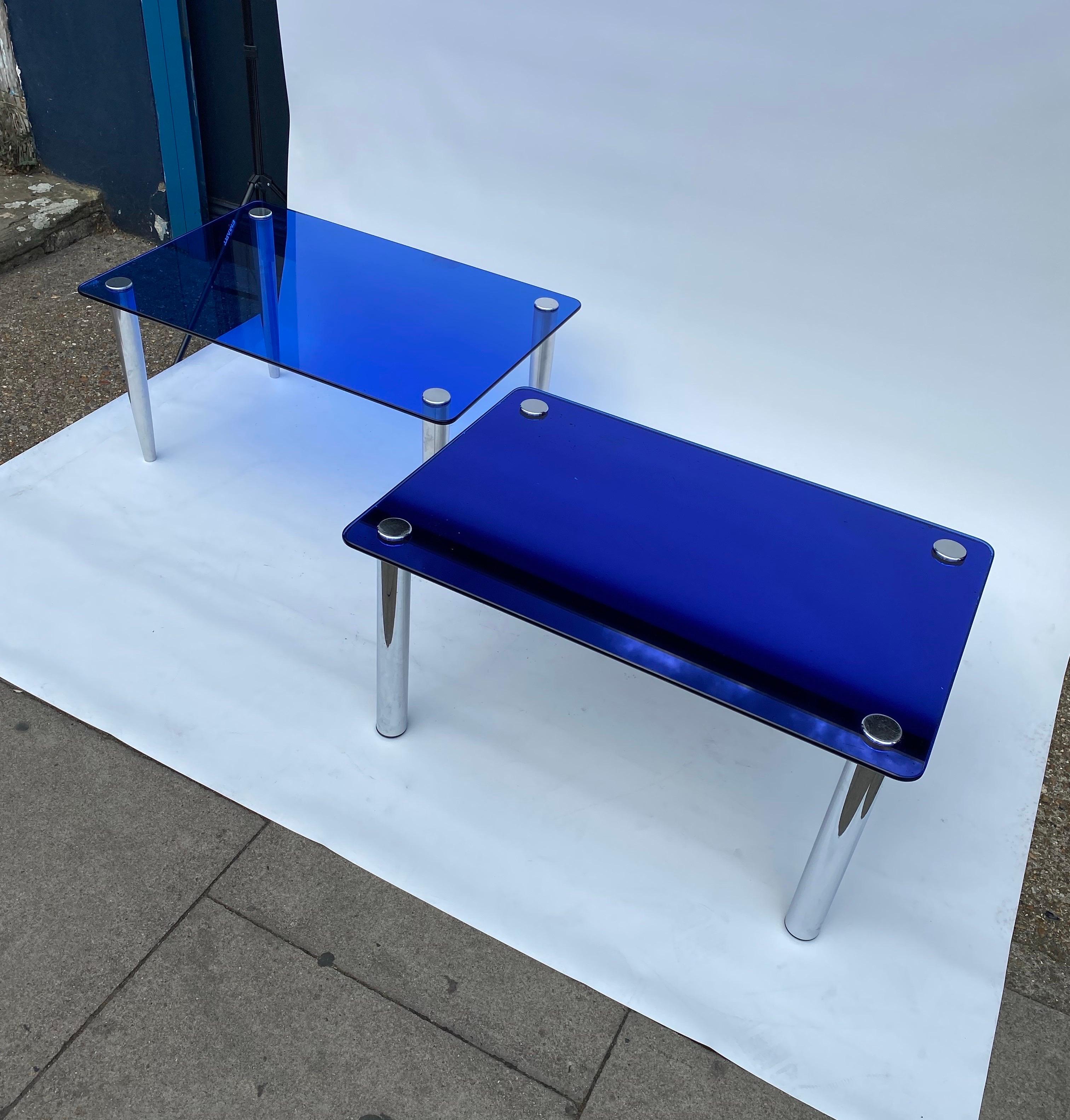 Imported from Lake Como, Italy this amazing pair of coffee tables featuring the characteristic and magnificent blue colour of Fontana Arte attached to each one of them four steel screw feet.

The blue smoked glass and mirrored glass top have a