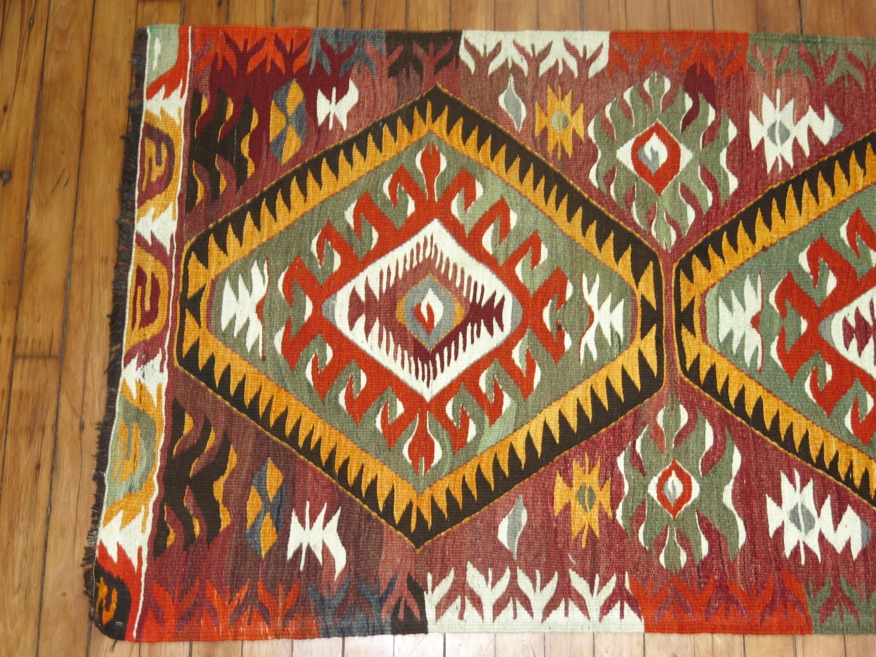 Rustic colored geometric mid-20th century Turkish Kilim throw rug, circa mid-20th century.

Measures: 2'6” x 4'4”.