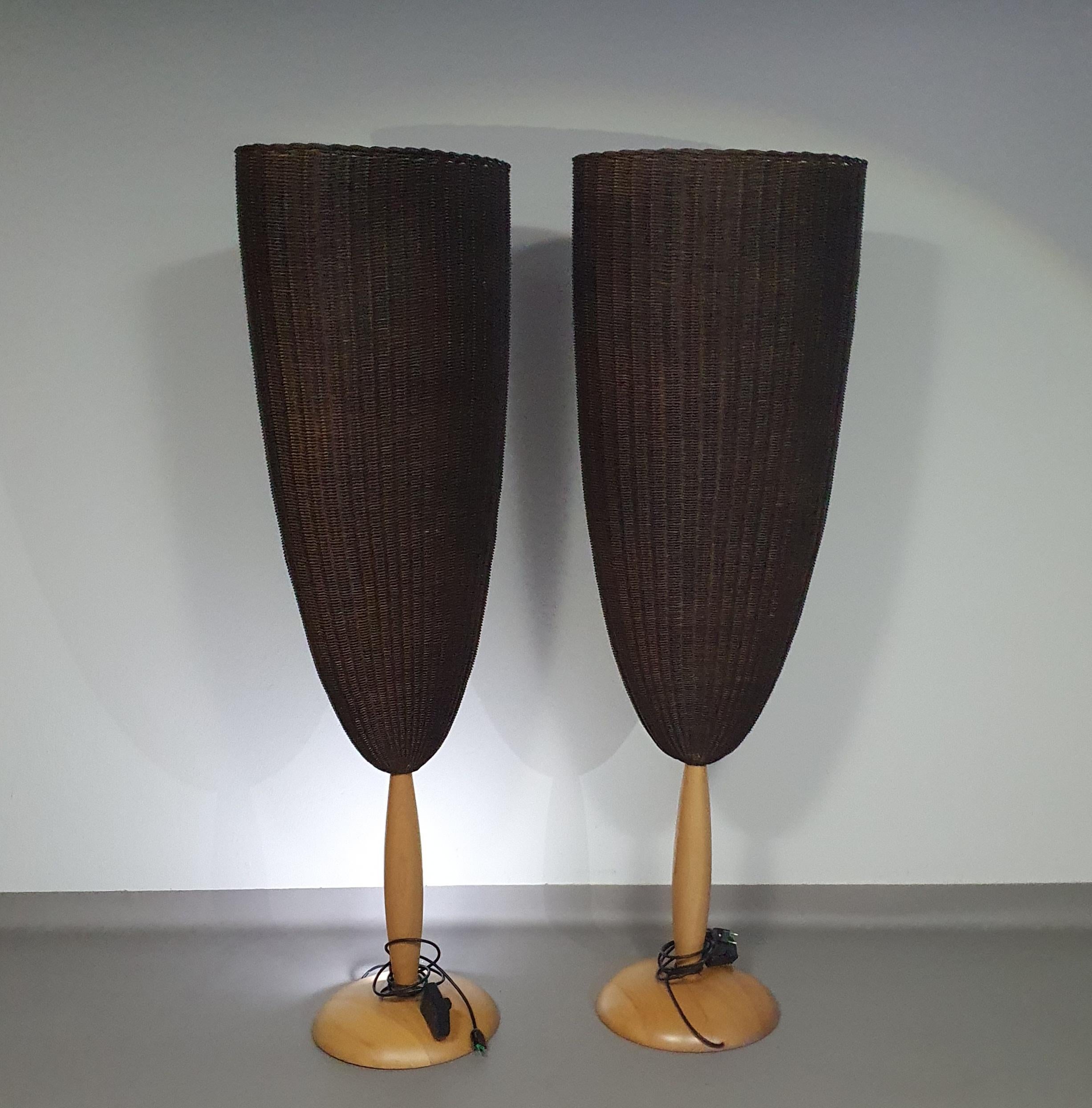Organic modern Flûte floor lamps with large woven cane lamp shade that sits upon a beech wood carved base designed by Marco Agnoli for Pierantonio Bonacina, Italy 1991.