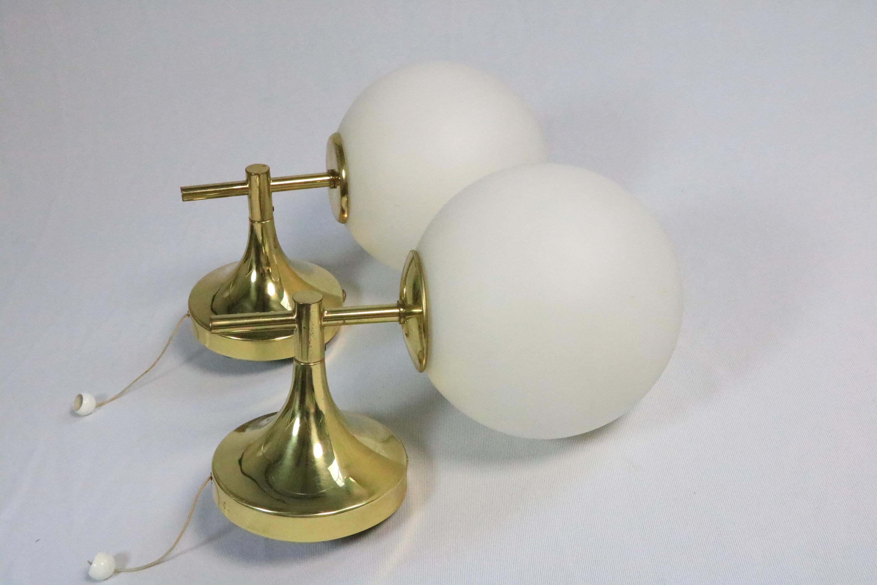 Two rare, very elegant wall lamps with opal glass balls and brass frames.

Manufacturer: Temde, Switzerland
Designer: E.R. Nele

The frame has a classic tulip shape.
There is a third almost identical lamp by Temde in chrome. If you would like to