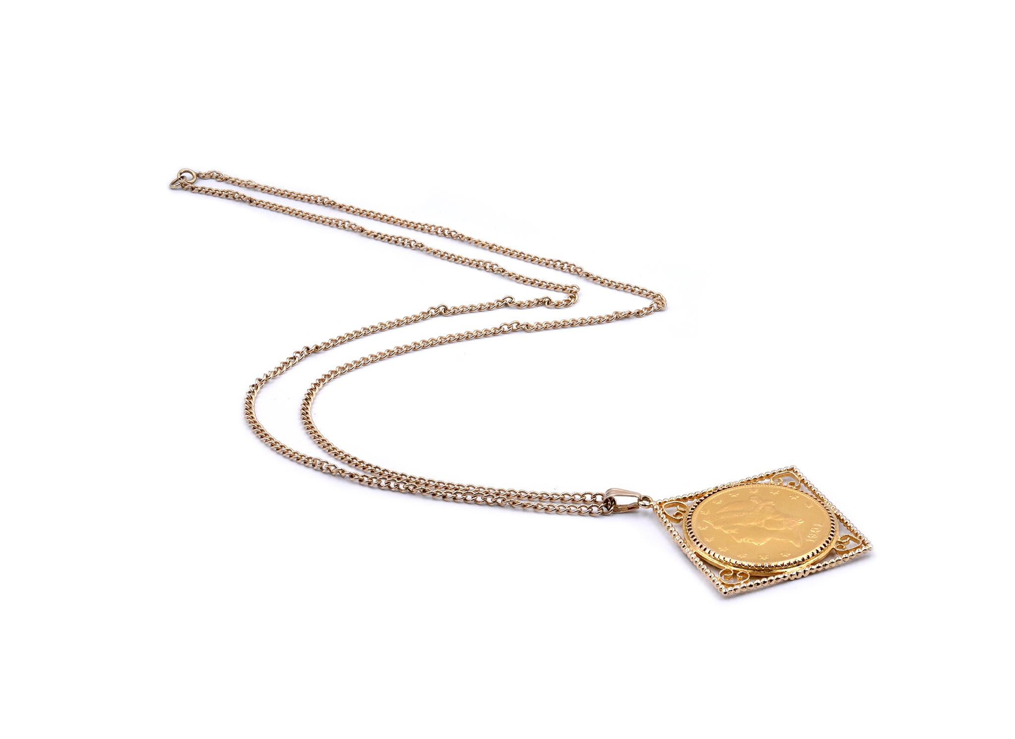 Designer: custom design
Material: 14K yellow gold
Dimensions: necklace is 32-inches long, bezel measures 55.50mm wide at the widest point
Weight: 58.62 grams
