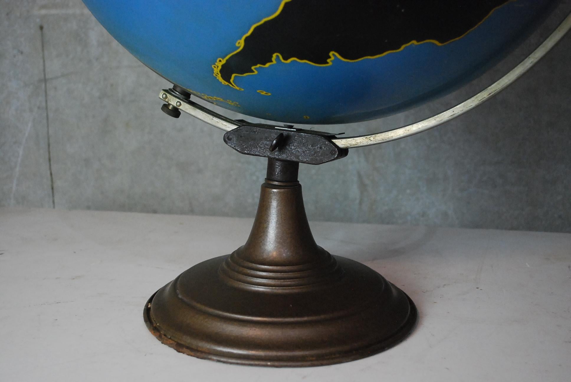 Denoyer Geppert of Chicago military world globe made of thick spun metal on a heavy iron stand. In chalkboard style features this was an educational teaching instrument. 
Nice original paint.
Solid condition with no missing or loose parts. Stands
