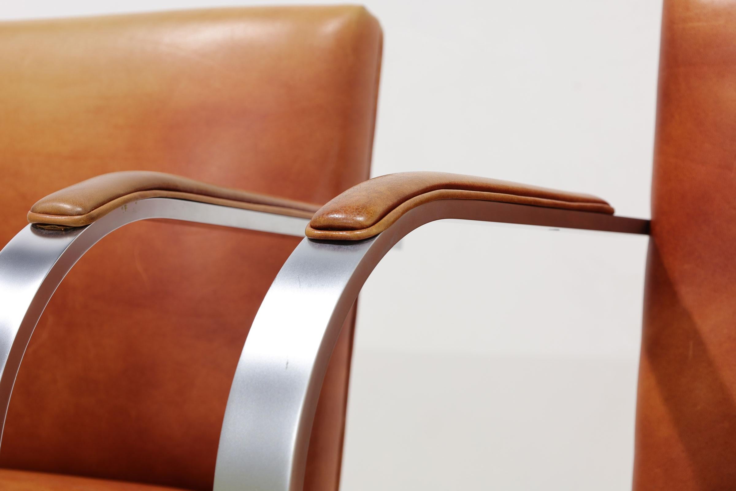 We have up to 20 Brno chairs by Mies van der Rohe for Knoll. They are upholstered in a distressed leather and have arm pads. Frame is a unique brushed steel. Chairs are stamped Knoll Studio.