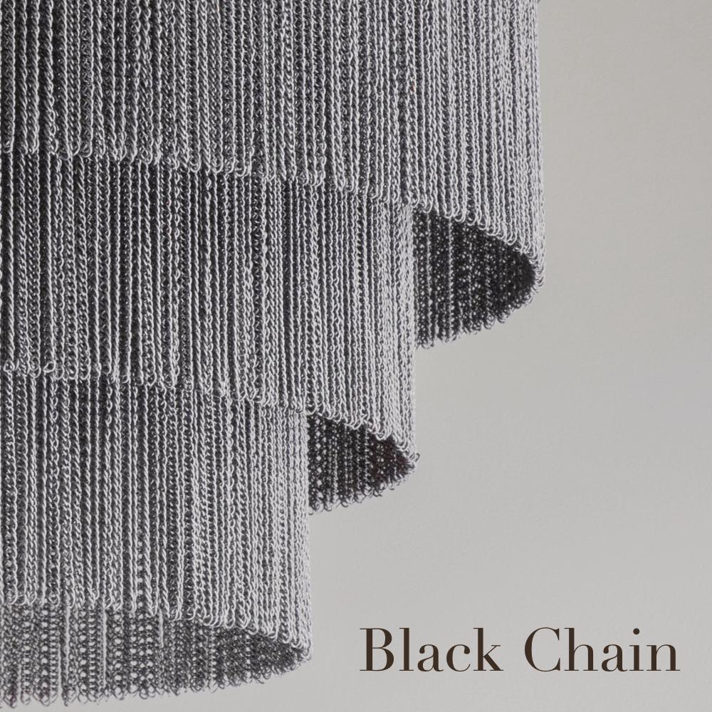 Contemporary chandelier with three shallow tiers of delicate chain strands and handcrafted metalwork. Available in bronze, gold or flat nickel metalwork with either black or silver decorative chain.

Designed and handmade by Tigermoth Lighting on