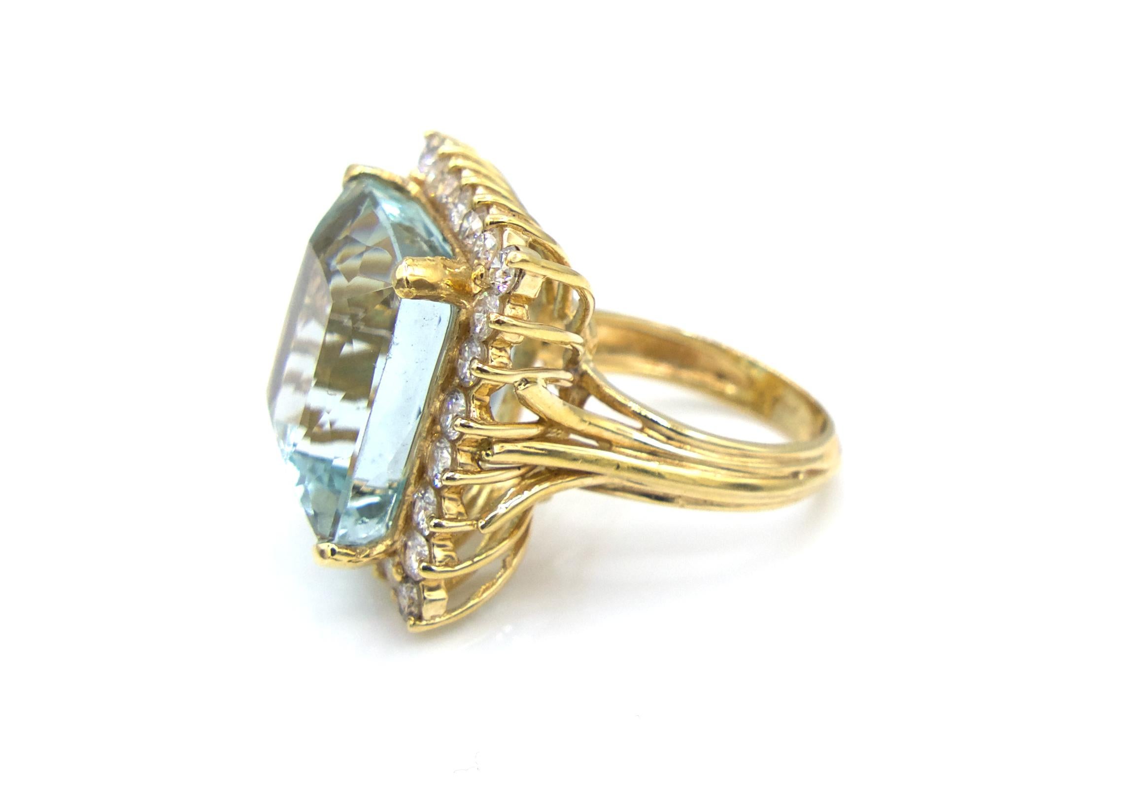 This original Ben Moses Jewelry Design ring is made with a remarkably bright 20 Carat Aquamarine center stone and 26 round-cut diamonds, totaling 2 carats, surrounding it. It also features a classic 14K Yellow Gold cage setting.

12.8 grams

Size