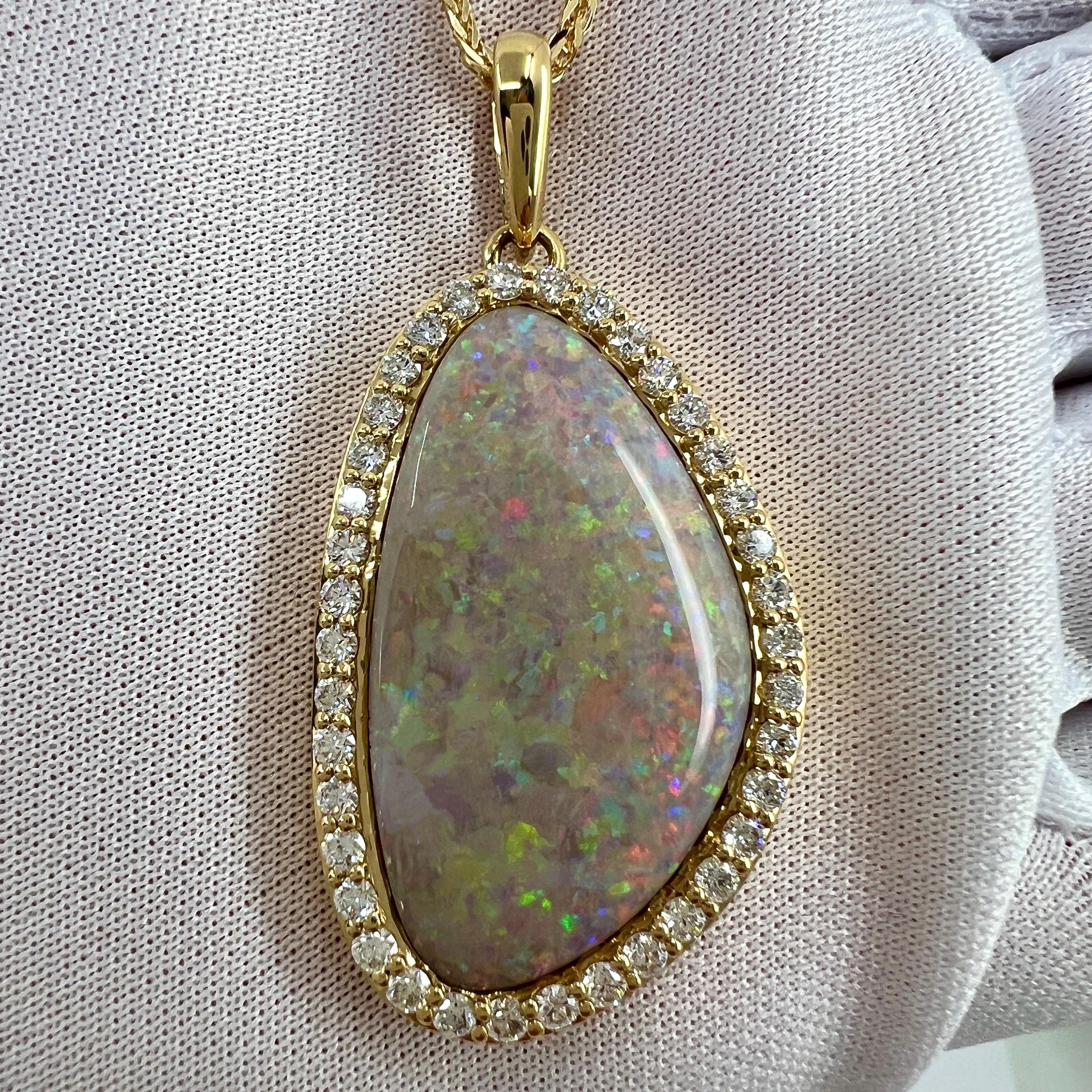 Fine Natural Australian Coober Pedy Opal & Diamond 18k Yellow Gold Pendant Necklace.

Large 20 Carat opal with beautiful play of colour, lots of colour flashes under direct light. Blues, greens, oranges, yellow, purple, reds... this stone is filled