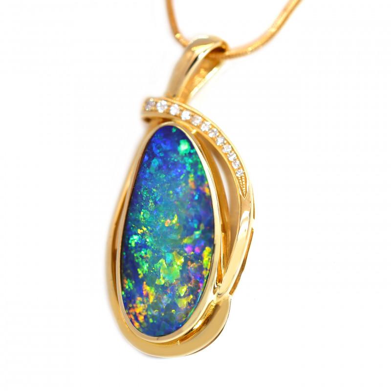 This bright Australian Opal Necklace stand out with the 12  Diamonds which really adds a touch of class.  Its set in 14k yellow gold and the opal is from Coober Pedy South Australia.
It Shows off Blues Yellows Greens and will sure impress anyone as