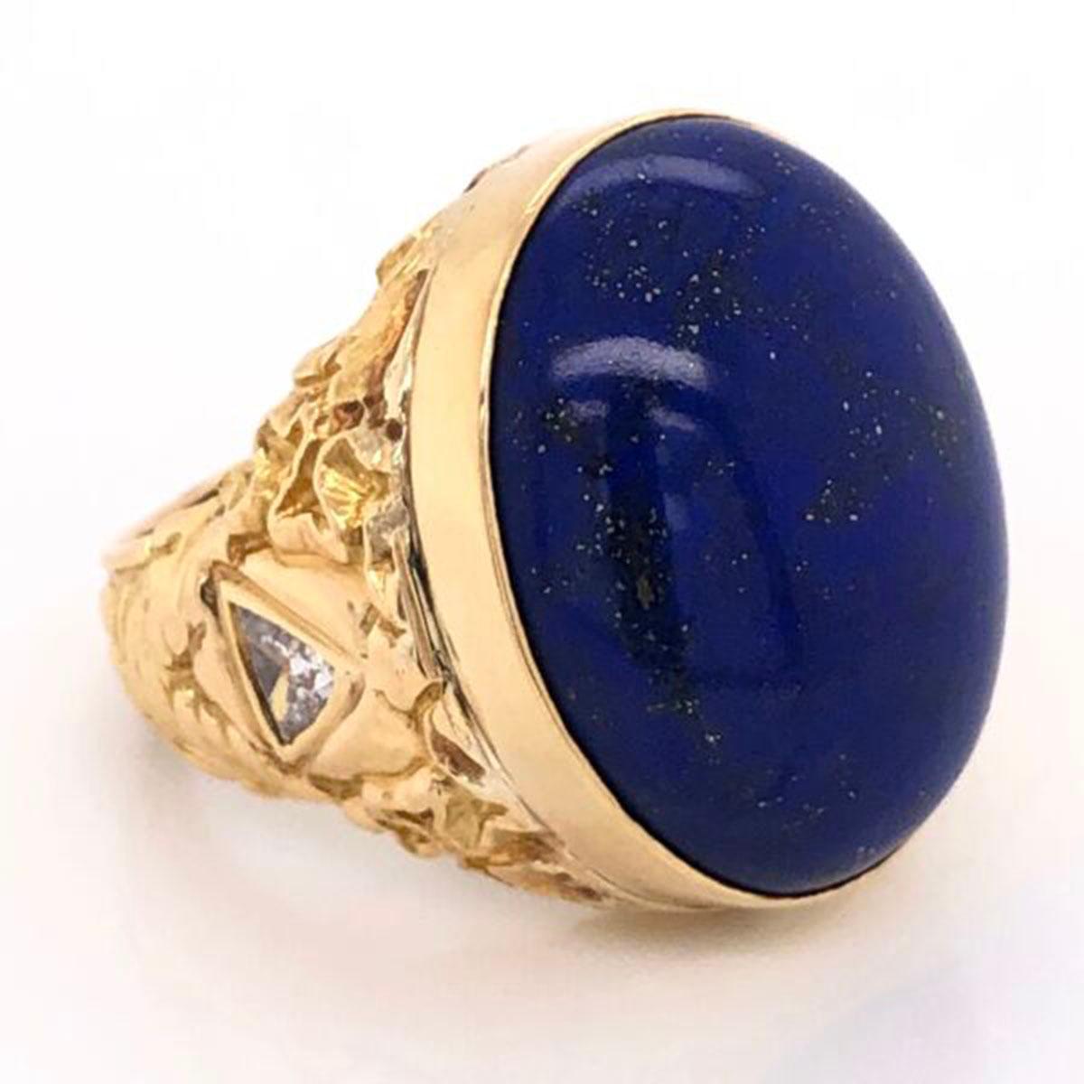 Magnificent Lapis Lazuli Ring, centering a large oval cabochon 20 Carat cabochon-cut Lapis Lazuli, bright blue with fabulous tones and small gold flecks, accented with 2 Trillion Diamonds with an approx. total weight of 1.00 Carats. This magical