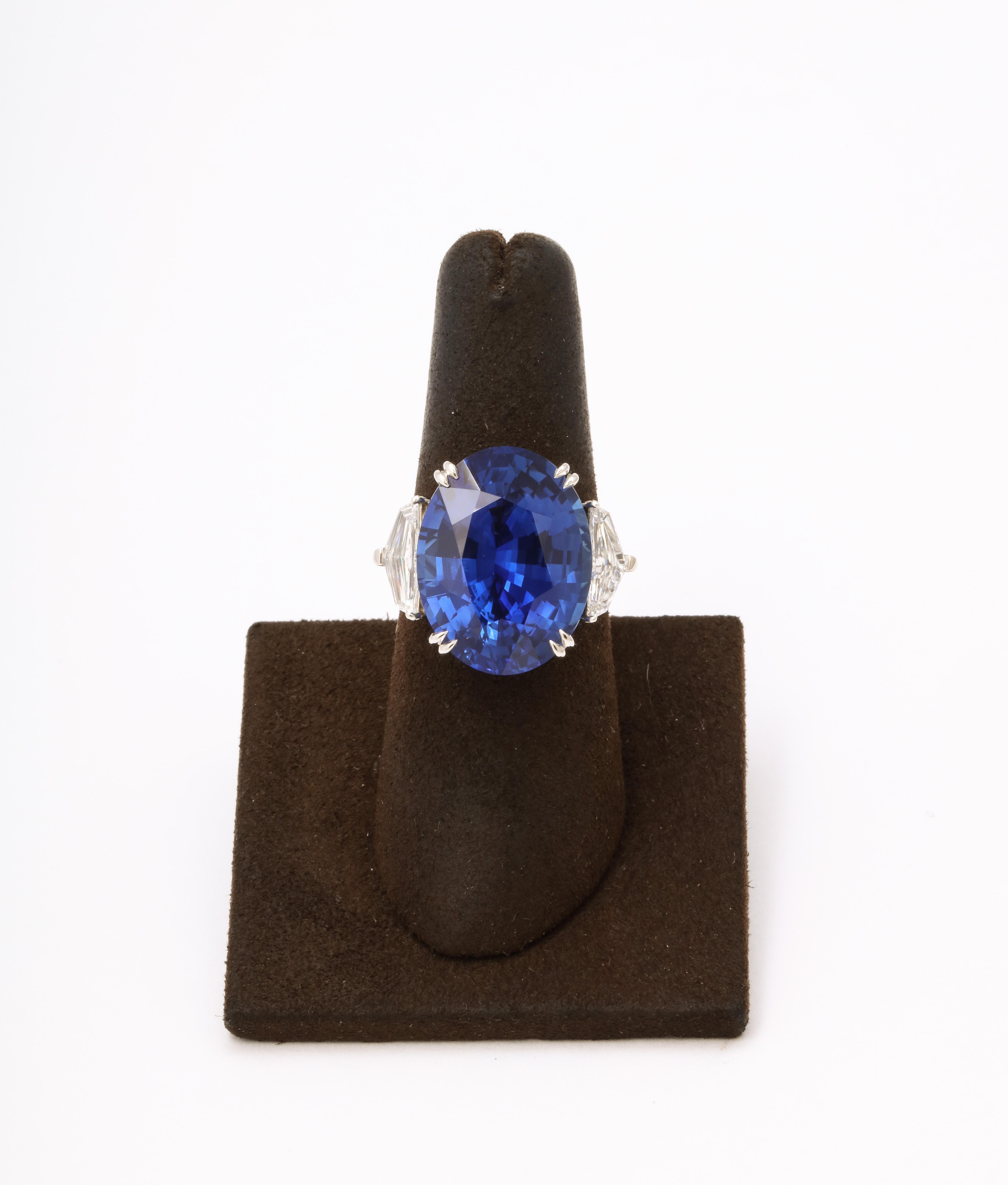 
An INCREDIBLE Sapphire! 

20.07 carat oval “Royal” Vivid Blue center Ceylon sapphire. 

1.32 carat white side diamonds 

Currently a size 6.25, this ring can easily be resized. 

Set in a custom platinum mounting. 

The sapphire is certified by two