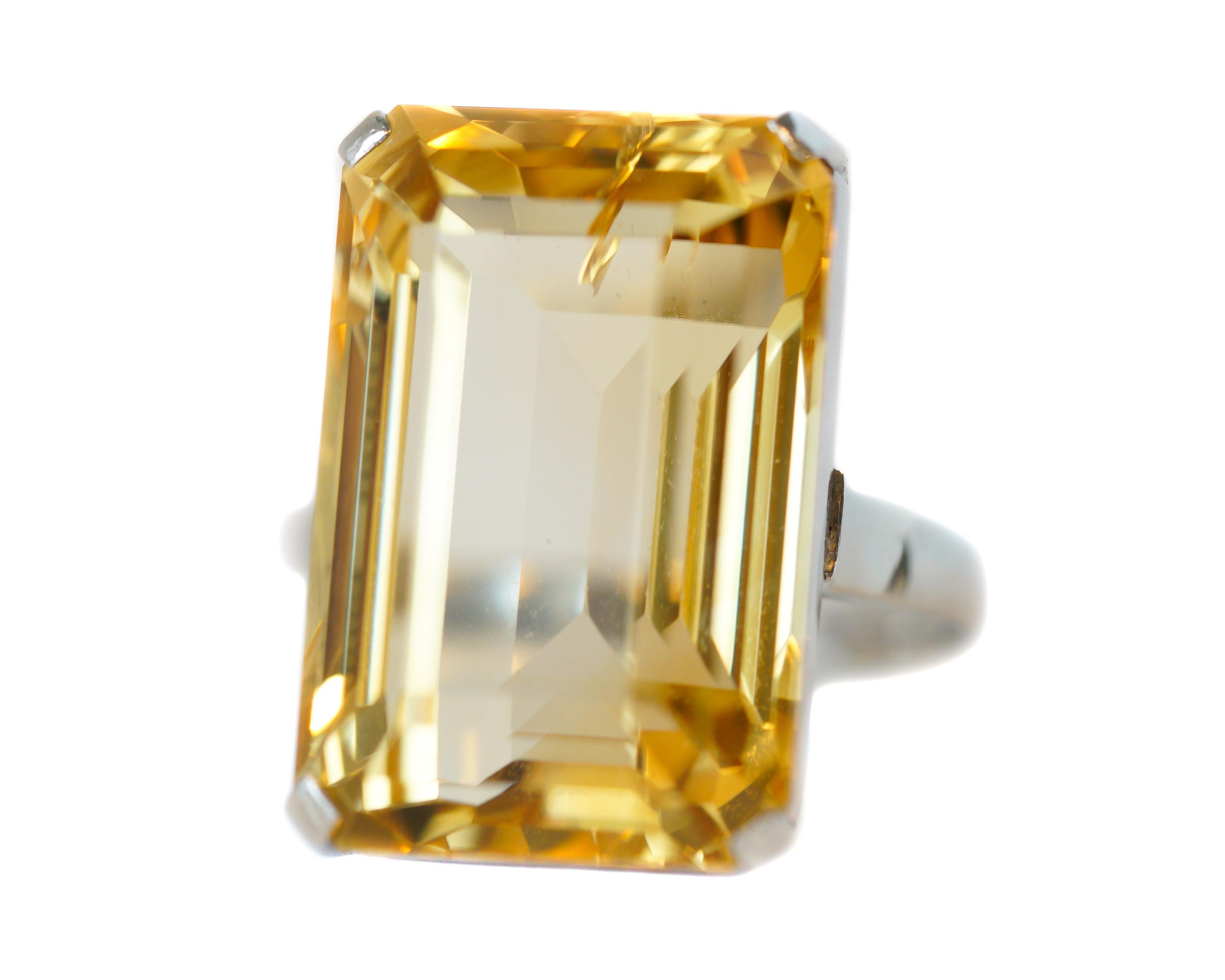 This gorgeous solitaire ring features a 20 carat Emerald cut Citrine. This stunning prong set gemstone is presented in a 14 karat White Gold setting with a decorative, open cutout, Art Deco- inspired gallery. 

Ring Details:
Size: 6, can be