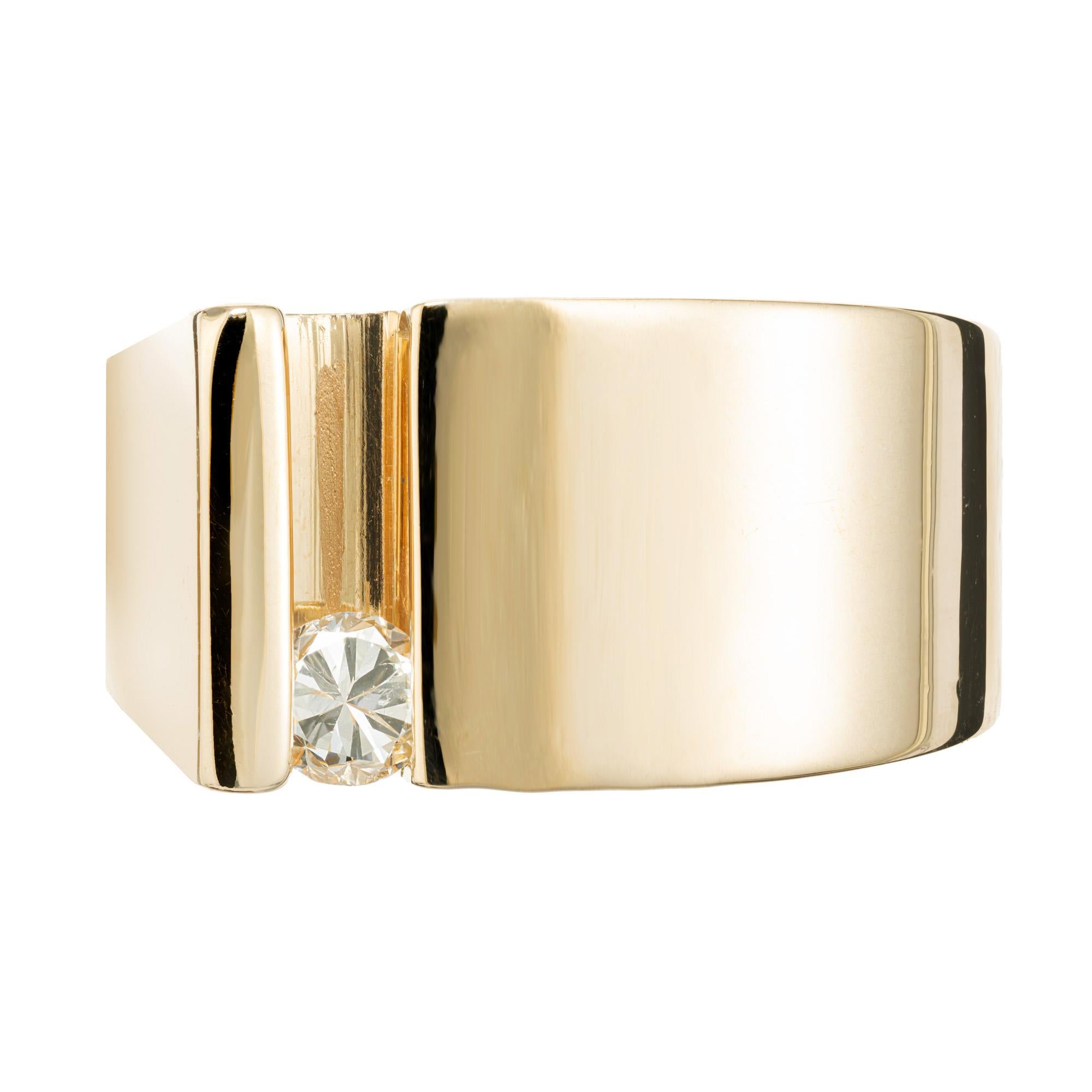 1970's modern design diamond slide 14k yellow gold ring that offers a unique and modern twist on a classic style. The single round diamond slides safely and securely back and forth as part of the design. The diamond has great brilliance with radiant