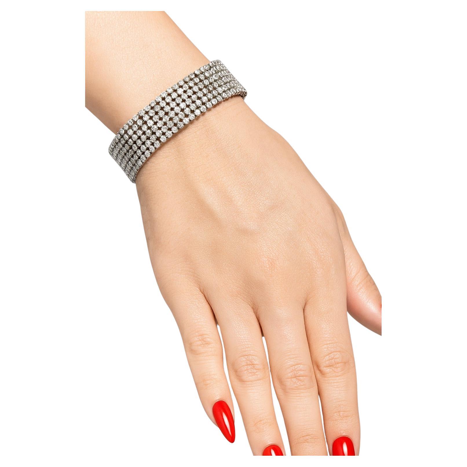 20 Carat Diamond 6-Row Wide Bracelet in 14K White Gold

This impressive estate bracelet is set with approximately 20 carats of natural diamonds, graded H color and SI1 clarity. Designed in six shimmering rows, the piece measures 8.5 inches in
