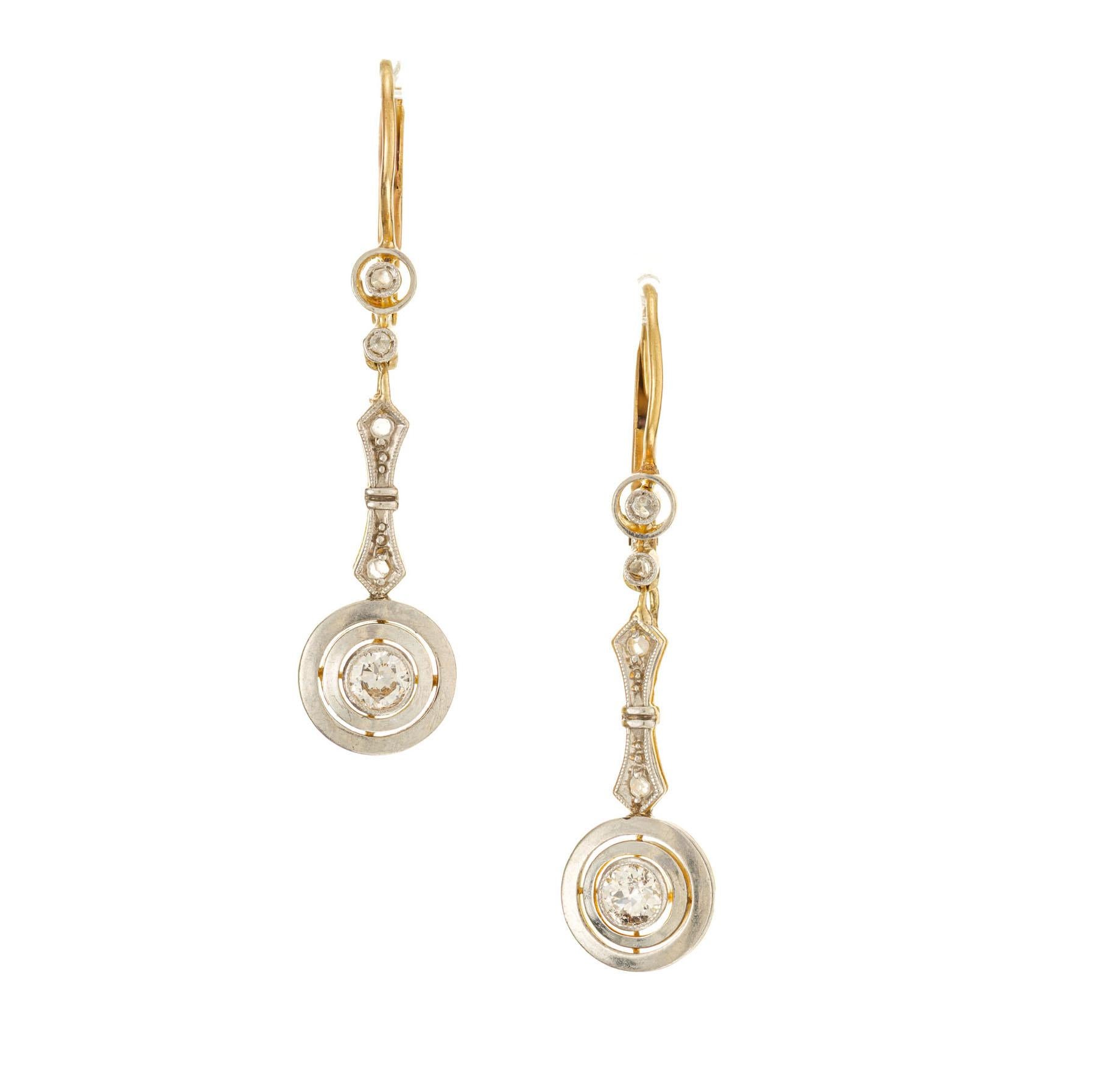 Antique 1920's diamond dangle drop earrings handmade with platinum tops over 14k gold. Natural patina

2 round brilliant cut diamonds, I SI-I approx. .20cts
8 rose cut diamonds, approx. .5cts
Platinum 
14k yellow gold 
2.7 grams
Top to bottom: