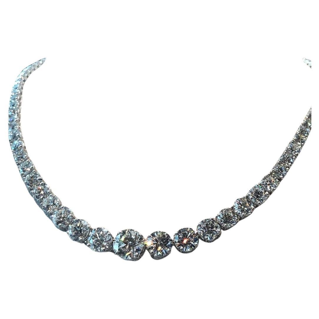 This timelessly elegant riviera necklace dazzles with 20 carats of beautifully white and vibrantly brilliant natural diamonds. The central diamonds are gracefully graduated, with the center weighing a quite substantial 1.50 carat. The sizeable