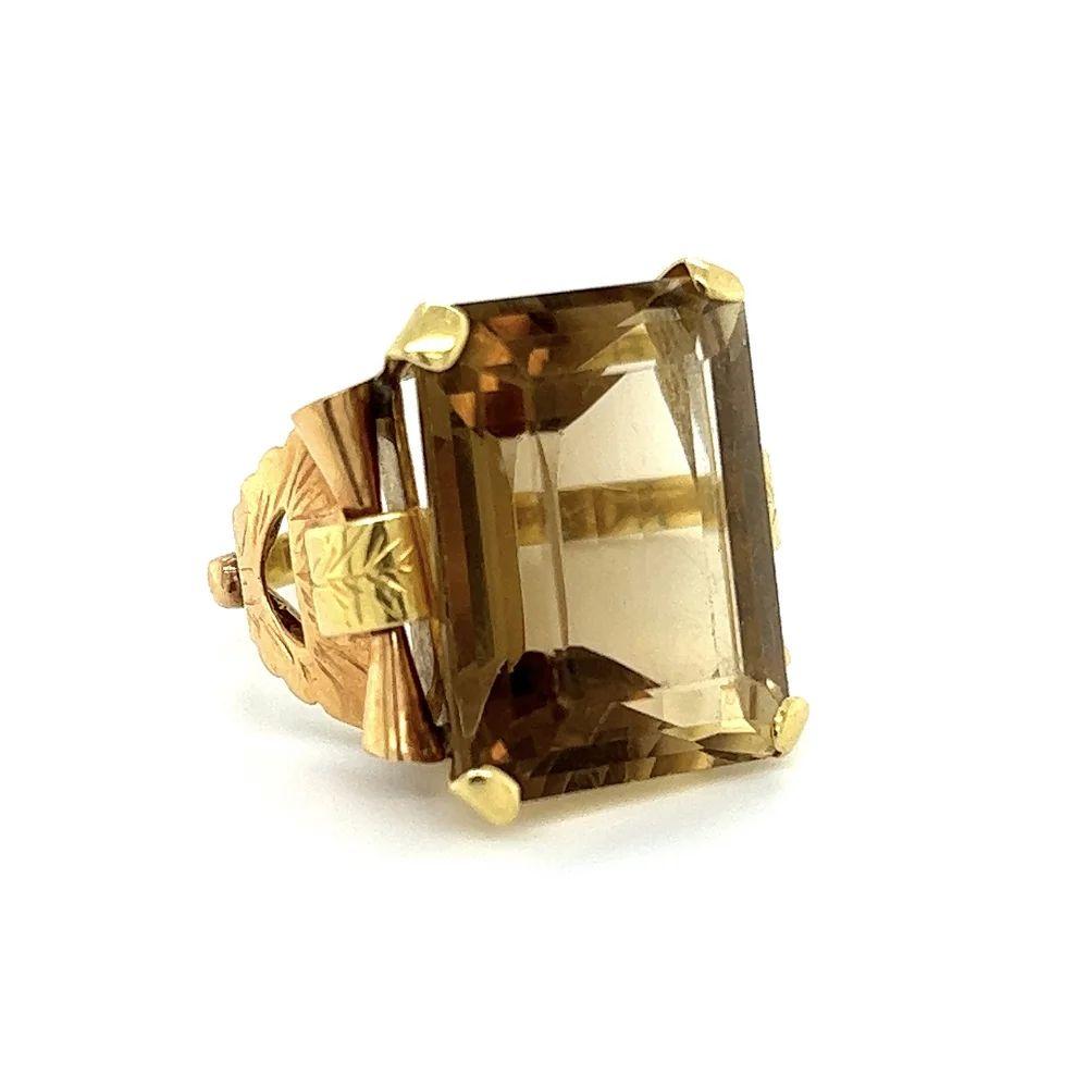 Simply Beautiful! Elegant and finely detailed Emerald Cut Smoky Quartz Gold Cocktail Ring. Centering a securely nestled Emerald-cut Smoky Quartz, weighing approx. 20 Carat. The ring is artfully Hand crafted in 2-Tone 18K Gold. Size 8, we offer ring