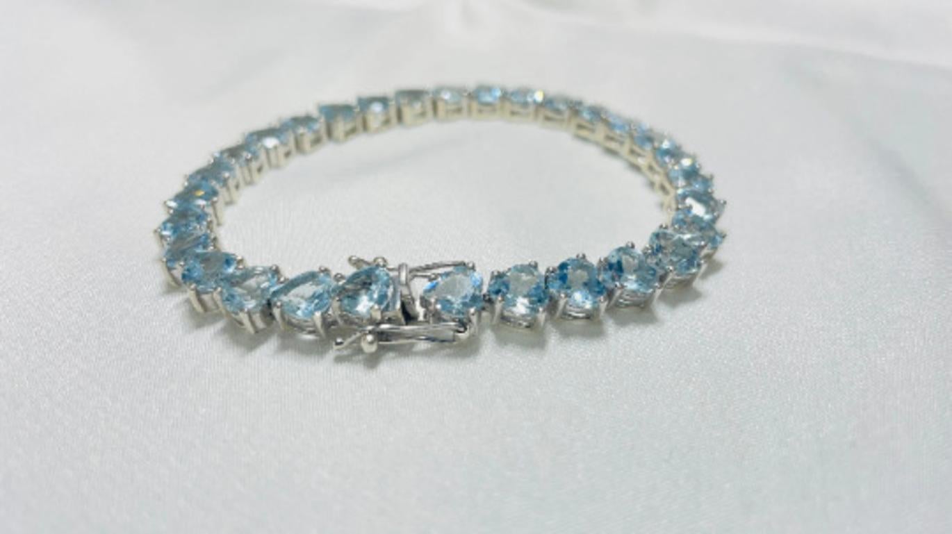 Beautifully handcrafted silver 20 Carat Heart Cut Aquamarine Wedding Tennis Bracelet, designed with love, including handpicked luxury gemstones for each designer piece. Grab the spotlight with this exquisitely crafted piece. Inlaid with natural