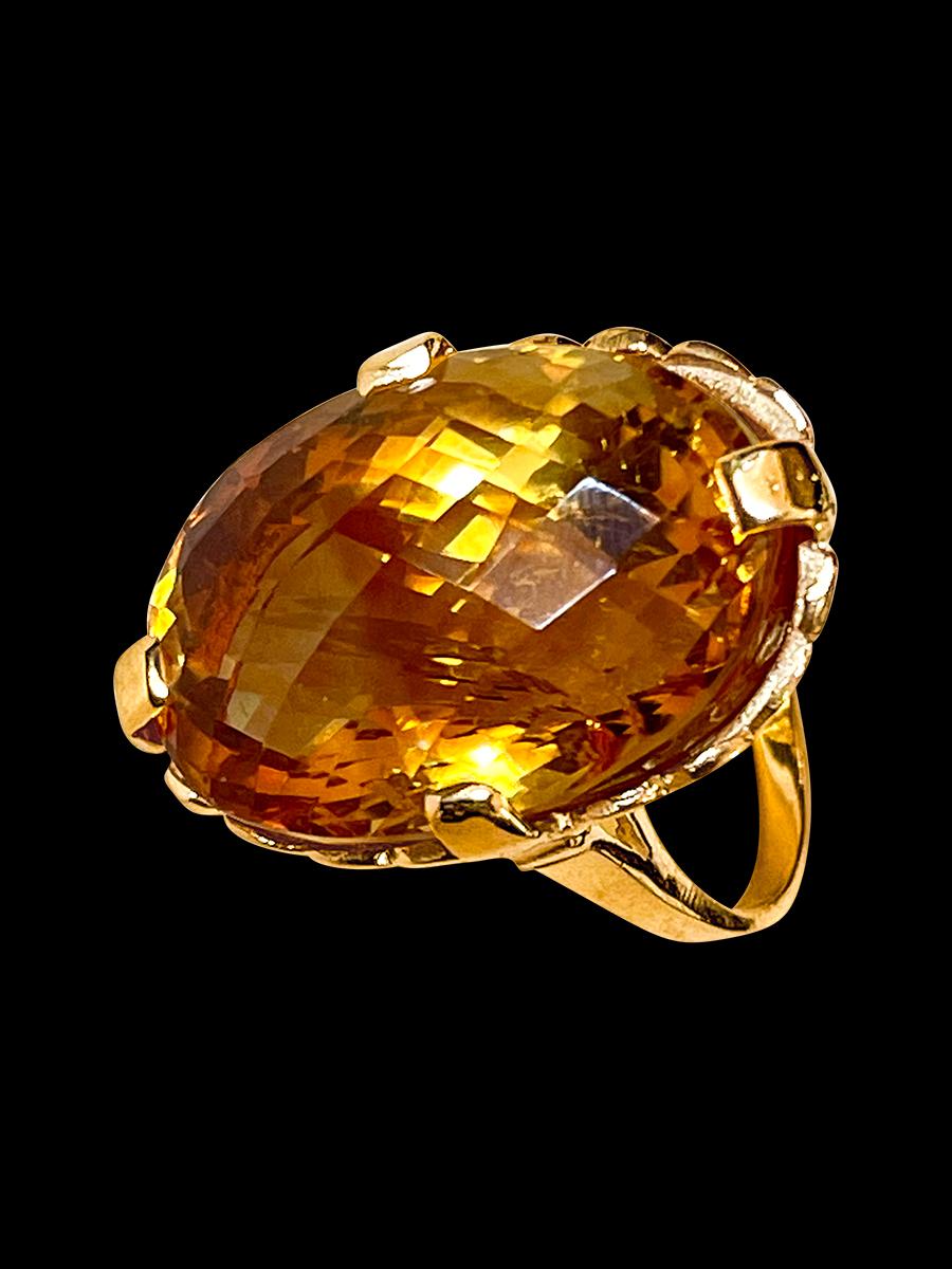 Approximately 20 Carat Natural  Long Oval  Checkerboard  Citrine Cocktail  Ring in 14 Karat Yellow Gold, Estate 
This is a ring which has a  approximately 20-22  carat of high quality Citrine stone. The stone is 25X18 MM and  14  mm Deep
Color and