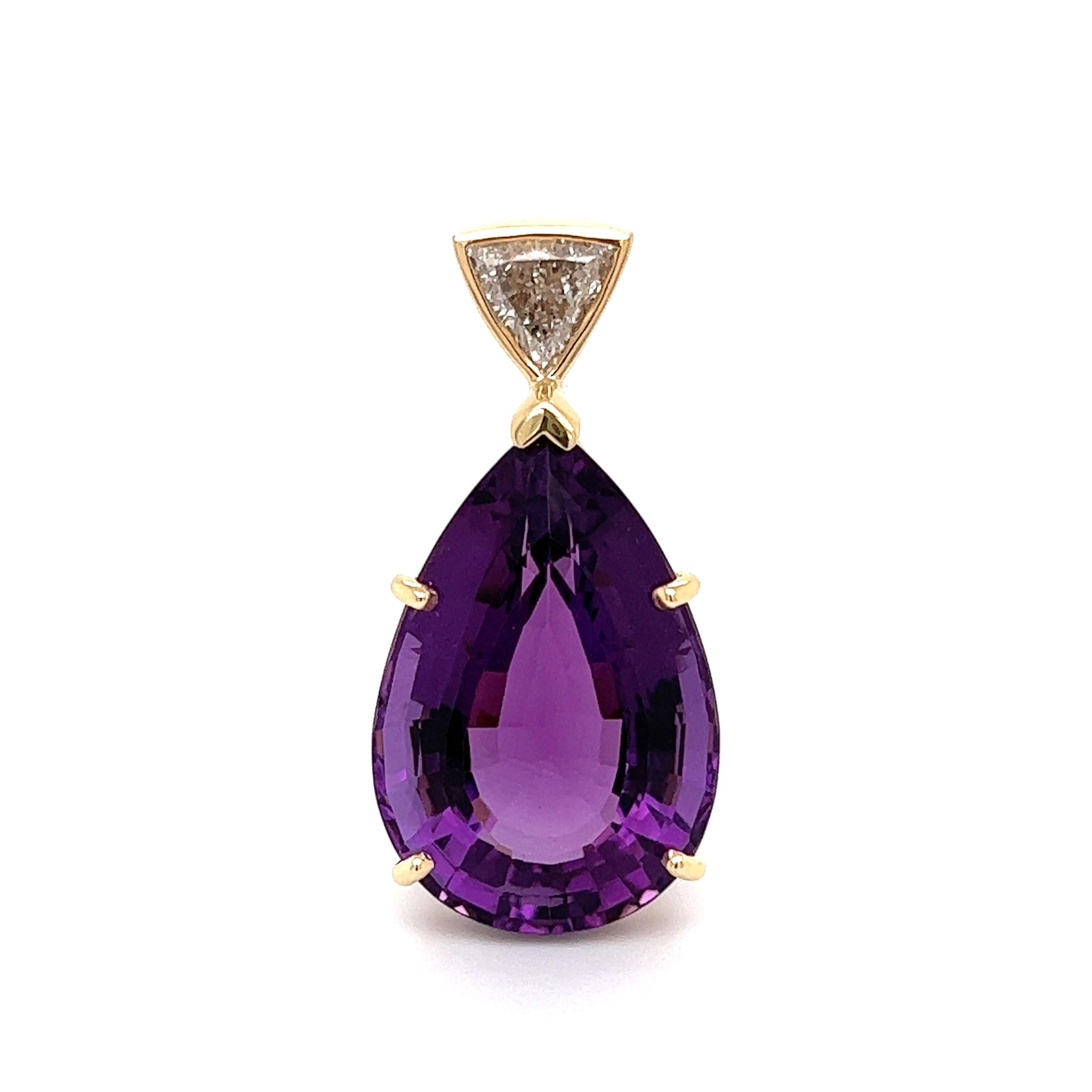 Simply Beautiful! Finely detailed 20 Carat Pear Amethyst and 0.75 Carat Trillion Diamond Gold Pendant Necklace Enhancer. Hand crafted 14K Yellow Gold. Measuring approx. 1.42” H x 0.70” W x 0.50” H. More Beautiful in real time! Chic and Timeless…Sure