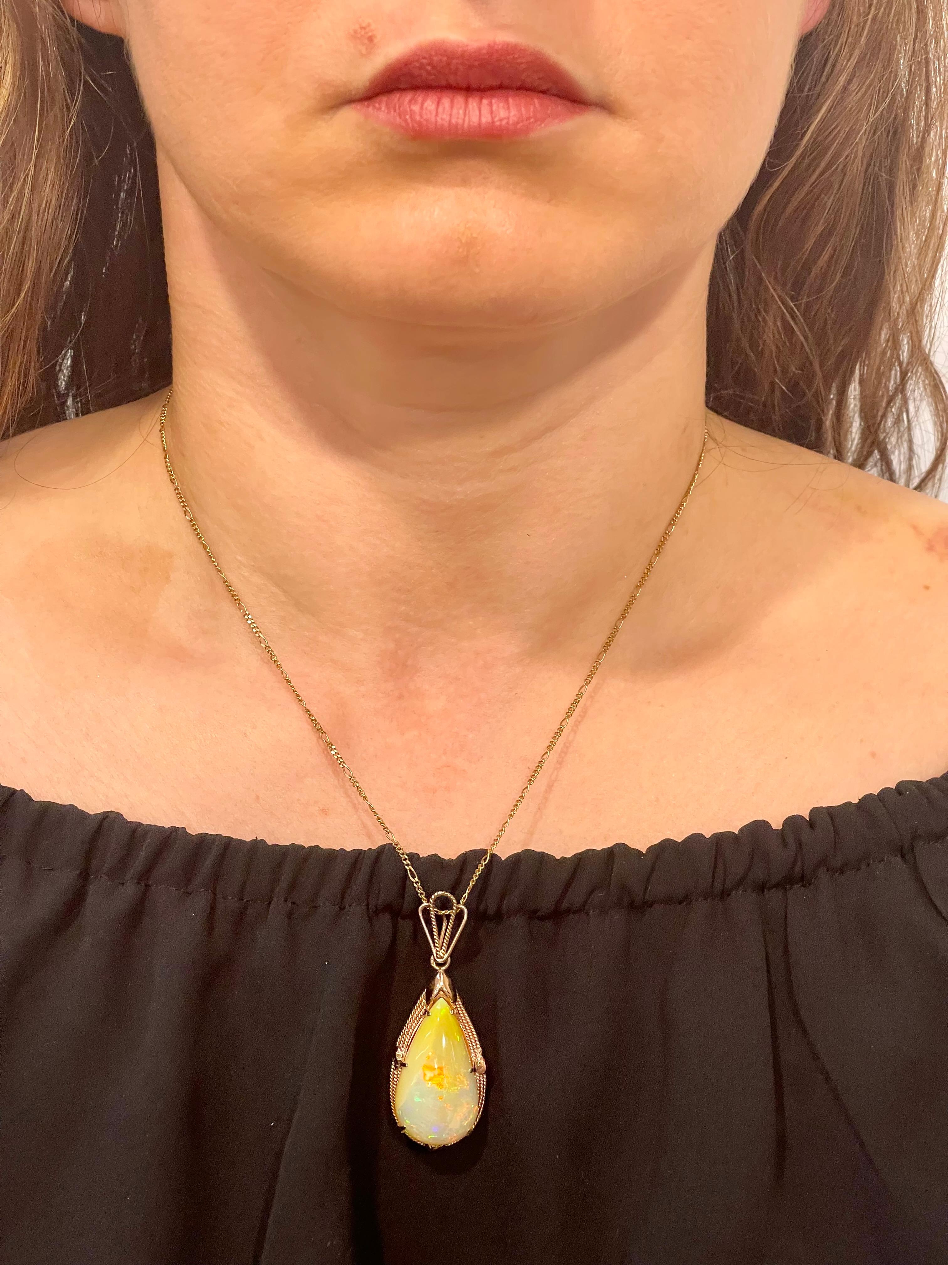 Approximately 18 Carat Pear Ethiopian Opal  Pendant / Necklace 14 Karat Yellow Gold Estate
This spectacular Pendant Necklace  consisting of a single Pear  Shape Ethiopian  Opal Approximately 18 Carat.  

14 Karat gold  10 Grams
The pendant comes