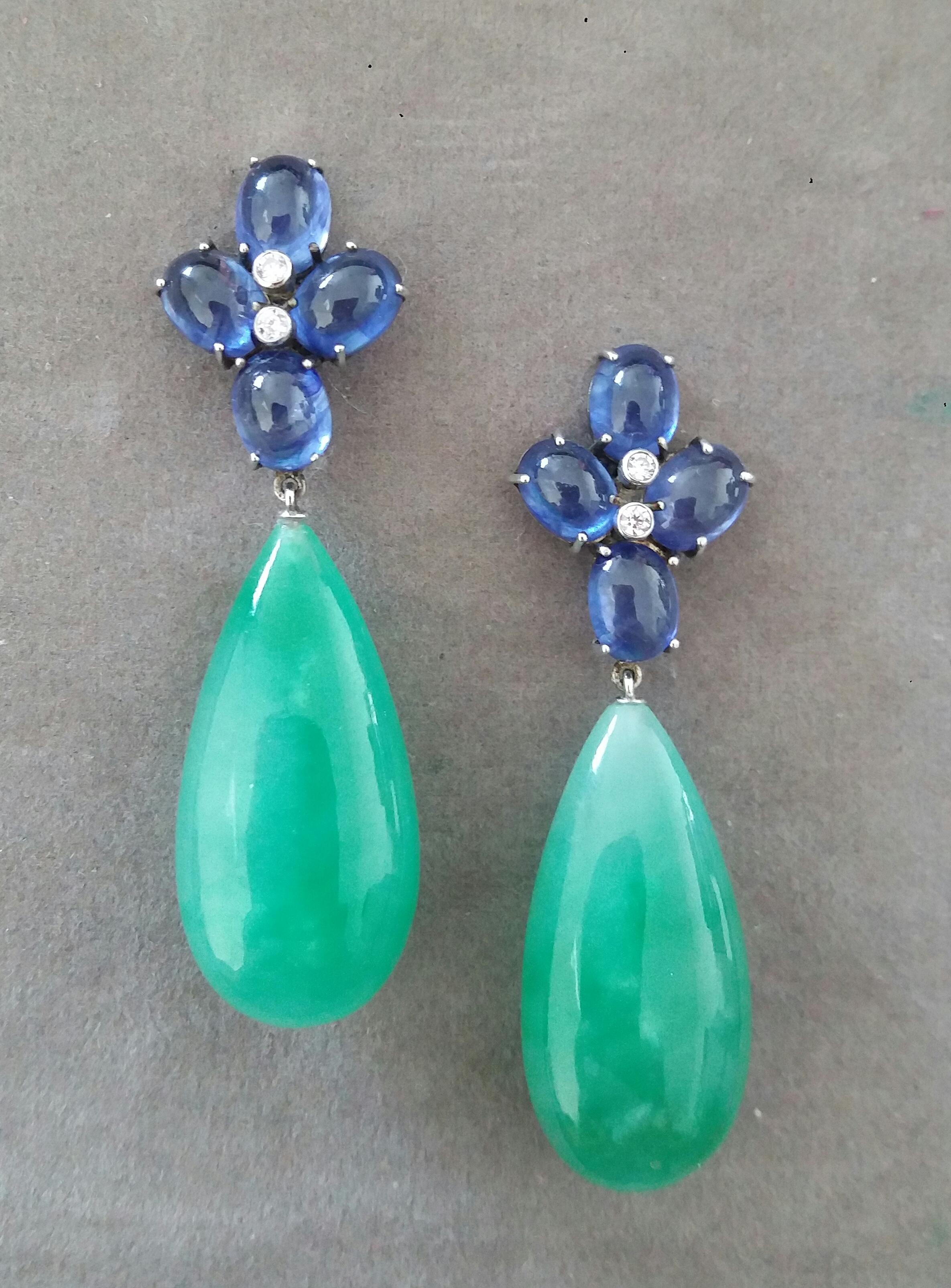 Elegant and completely handmade Earrings consisting of an upper part of 4 oval shape Blue Sapphires 6x8 mm  and weighing 20 Carats set together in 14 Kt white gold with 2 small diamonds in the center, at the bottom we have 2 Pear Shape Jade Drops