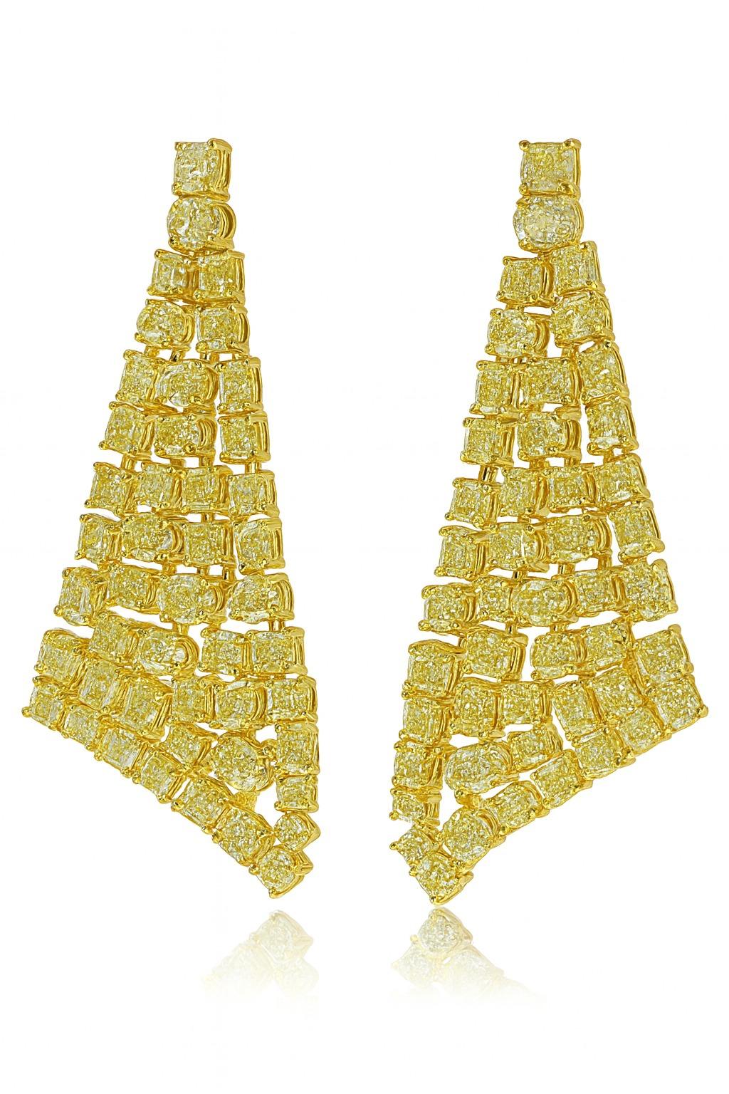Extraordinary Fancy Yellow Diamond Earrings
These spectacular earrings feature a mix of cushion-cut diamonds with a combined weight of 19.10 carats — an impressive and rare total. The diamonds are a vibrant Fancy Yellow, with VS1–SI1 clarity,