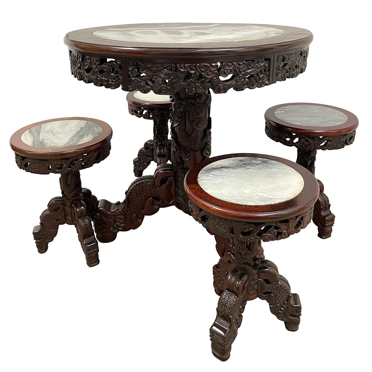 This gorgeous antique Chinese marble top hardwood round dinning table set were made of solid hardwood. It features hand carved wood works of traditional Chinese folks art of dragon motif and cloud design on the side of table, stools and Leg support.