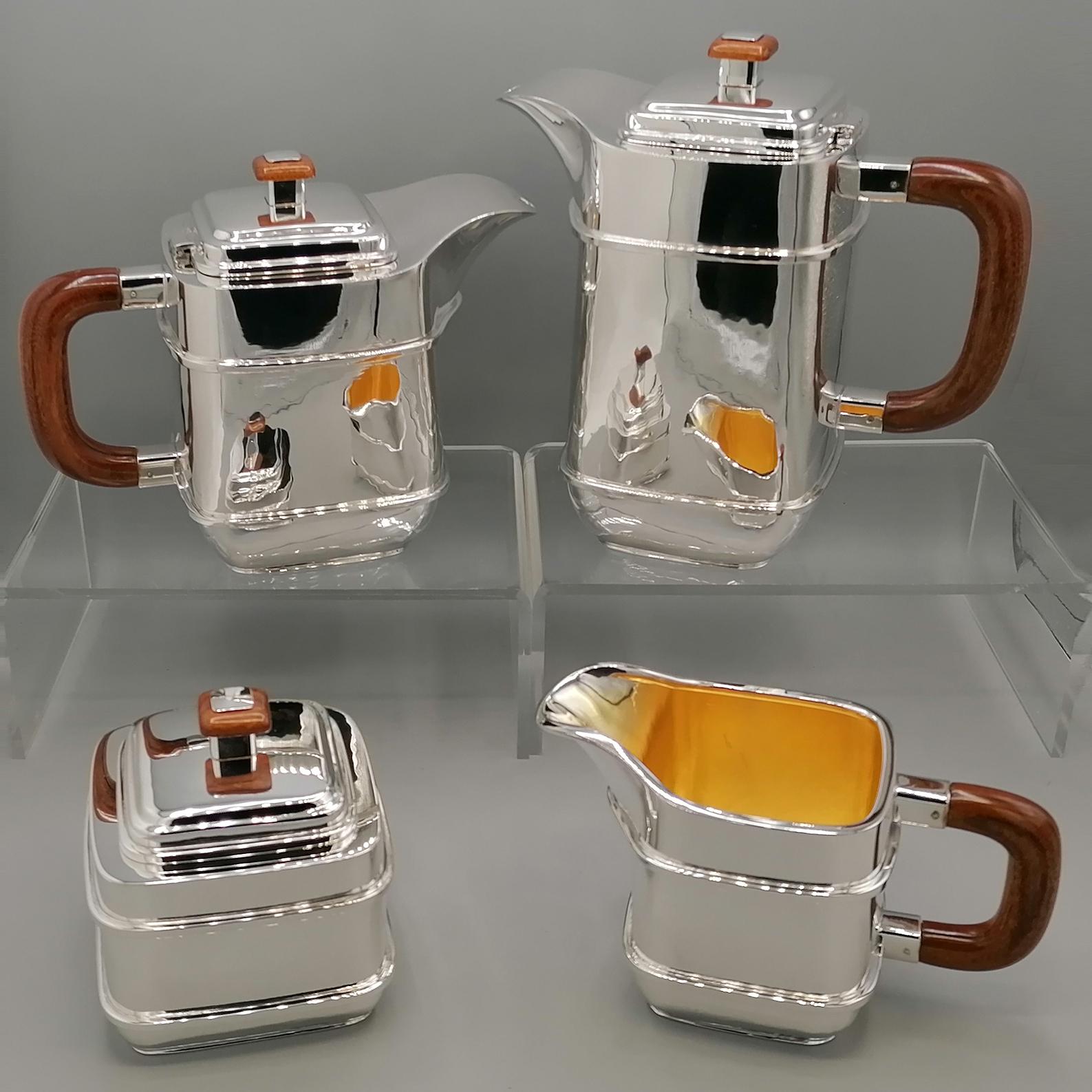 Art Deco style sterling silver tea and coffee service.
The body shape is square and completely smooth, polished with pumice stone.
Two square-section sterling silver wires were soldered onto the body to give the piece an elegant shape while not