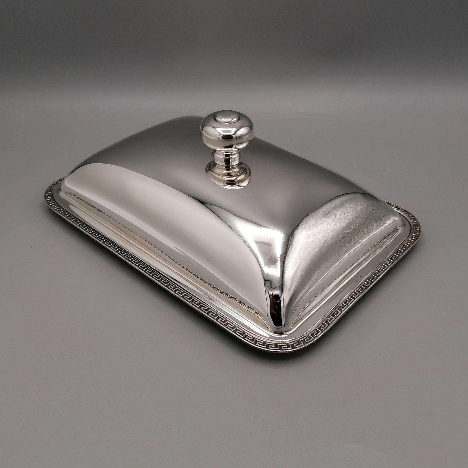 Sterling silver butter dish.
It is rectangular in shape with rounded corners, a neoclassical style border has been welded onto the edge of the tray.
A liner has been placed in the tray where the butter will be placed.
A smooth convex lid completes