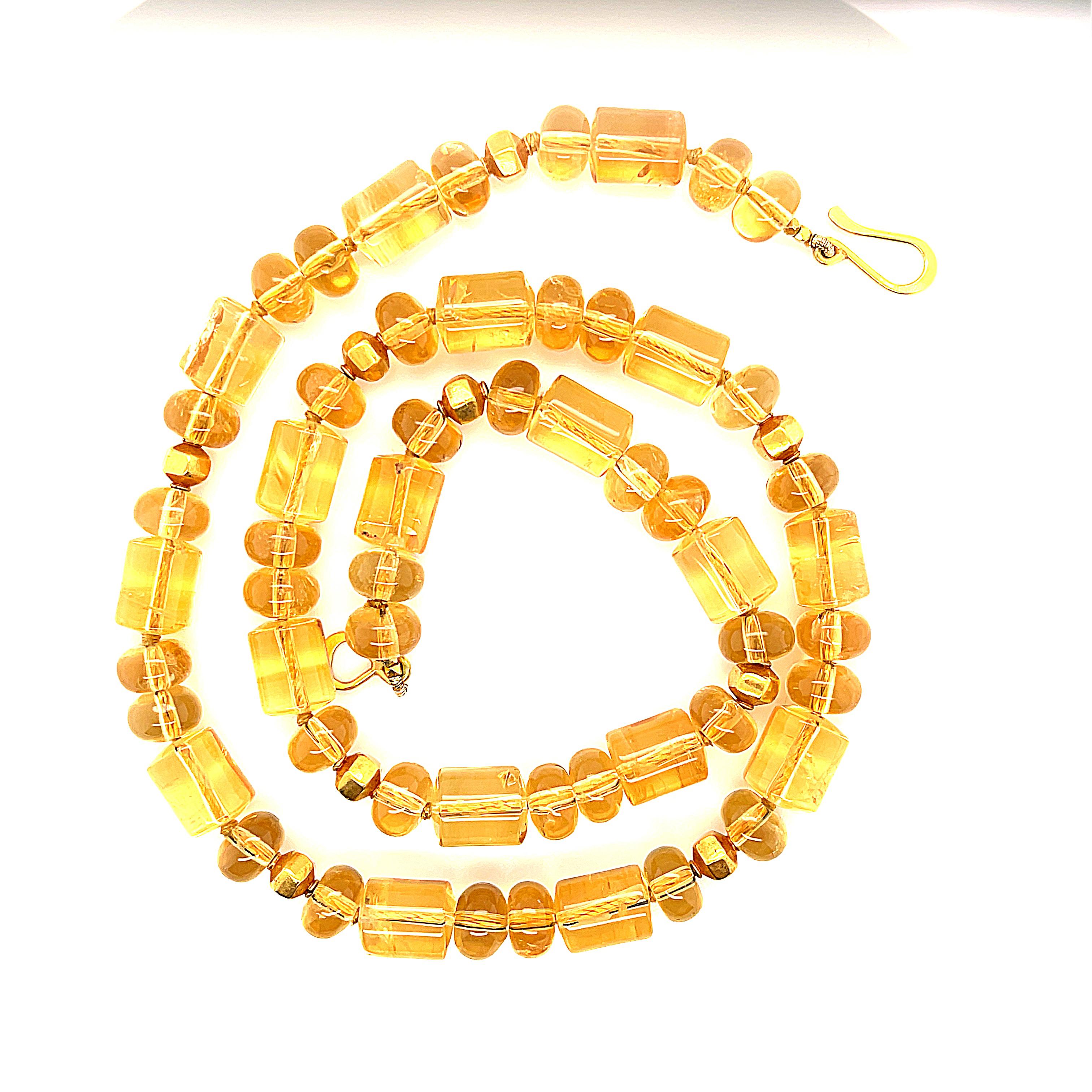 The warm glow of these beautiful citrine beads brings sunshine to everyday life! This golden strand of barrel-shaped and oval citrine beads has been carefully strung with 18k and 22k yellow gold accents, elevating this necklace to new heights.