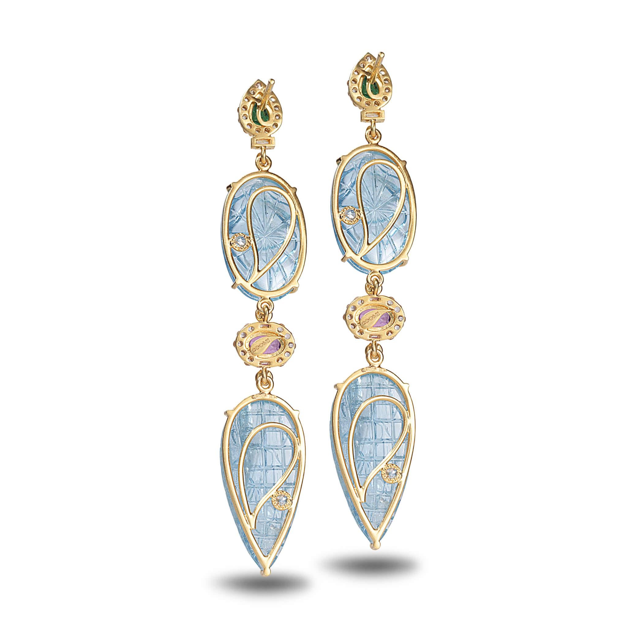 Affinity earrings set in 20K yellow gold with 44.32cts hand carved aquamarine, 1.05cts pink sapphire, 1.01cts diamond, and 0.99cts tsavorite.
