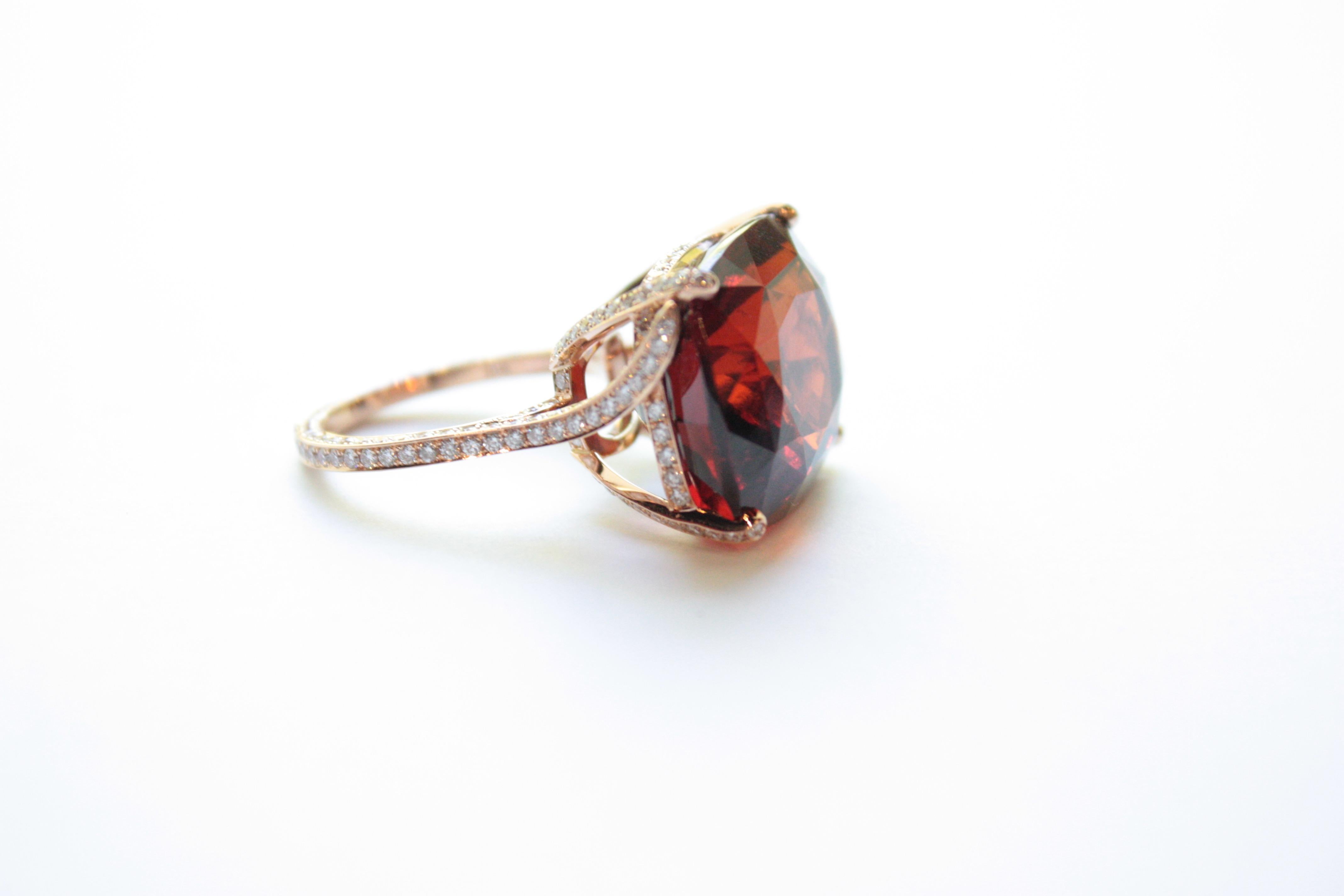 Garnet Big Ring
A twenty-karat rose gold ring showcasing a large 28.86 carat garnet.  The entire shank, leading up to and holding the center stone in place, has been encrusted on all three sides in white diamonds. 
Size 6 - adjustable upon request
