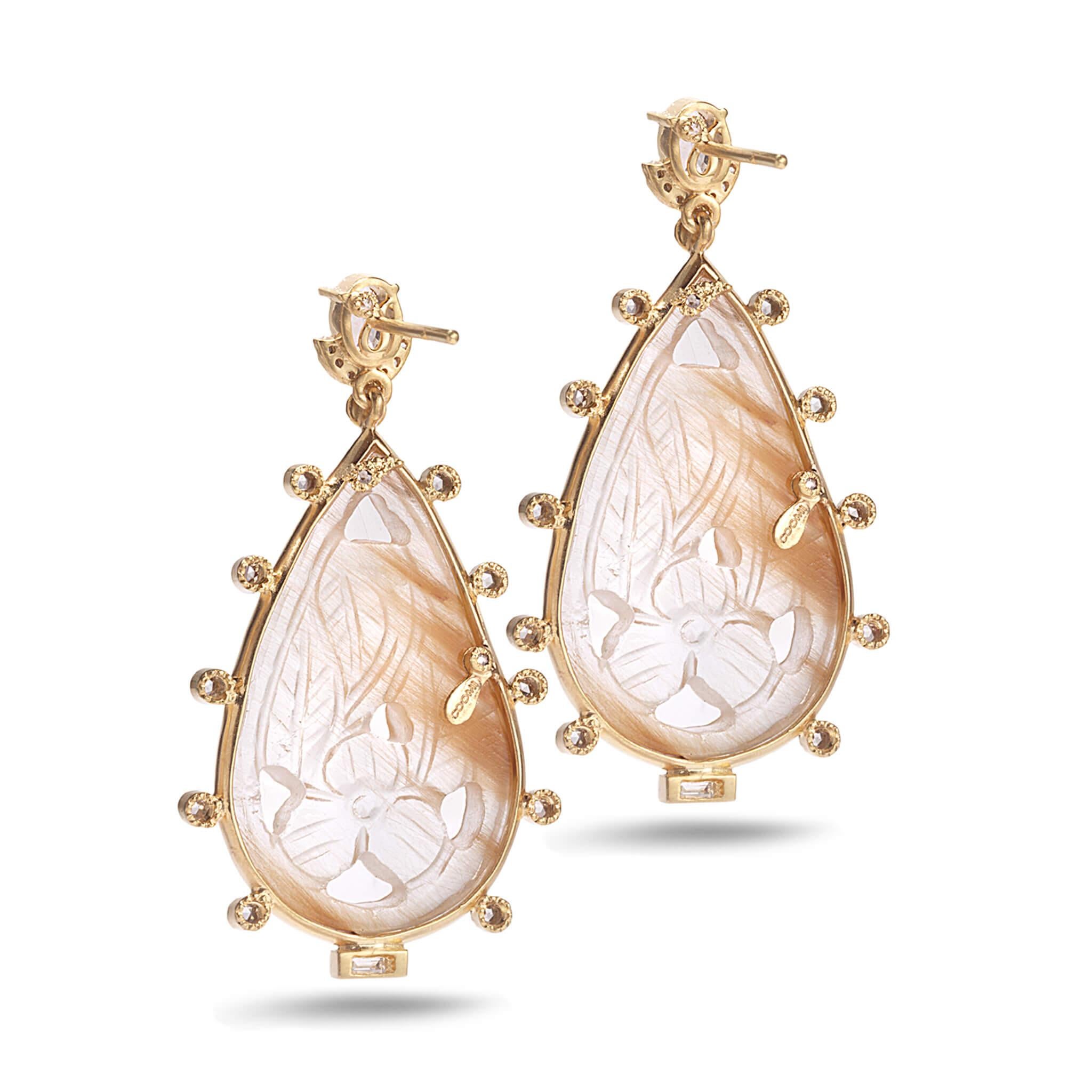 Affinity drop earrings set in 20K yellow gold with 30.07cts hand carbed rutilated quartz, 1.18cts white sapphire, and 0.63cts diamond.
