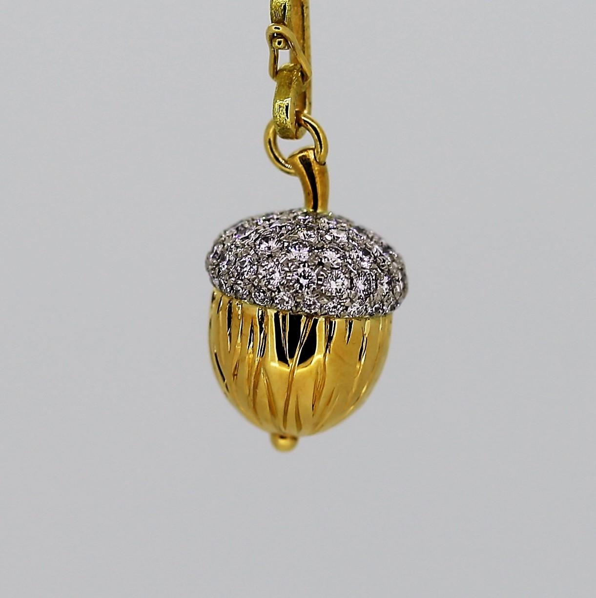 This 20 karat yellow gold leaf necklace is strung on a platinum chain and has a total length of 18 inches.  It lays beautifully on the neck and is accented by a removeable acorn charm that is 20 karat yellow gold with a platinum diamond cap.  The