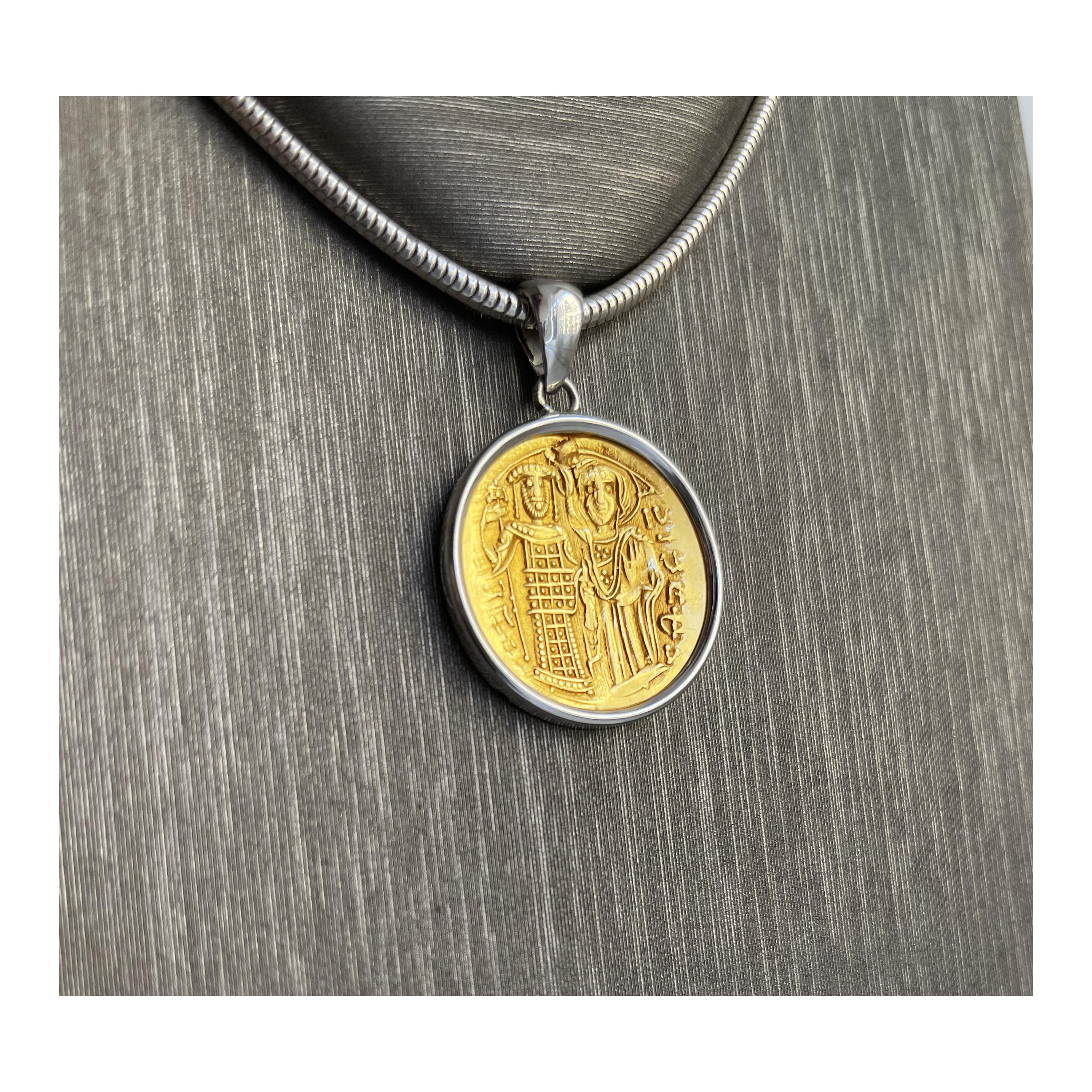 A 20 kt gold Byzantine coin depicting Emperor John III (1222-1254 AD) crowned by the Virgin Mary is set in a  sterling silver pendant ; in the reverse side of the coin there is Christ Pantocrator enthroned facing.
John III Doukas Vatatzes, was