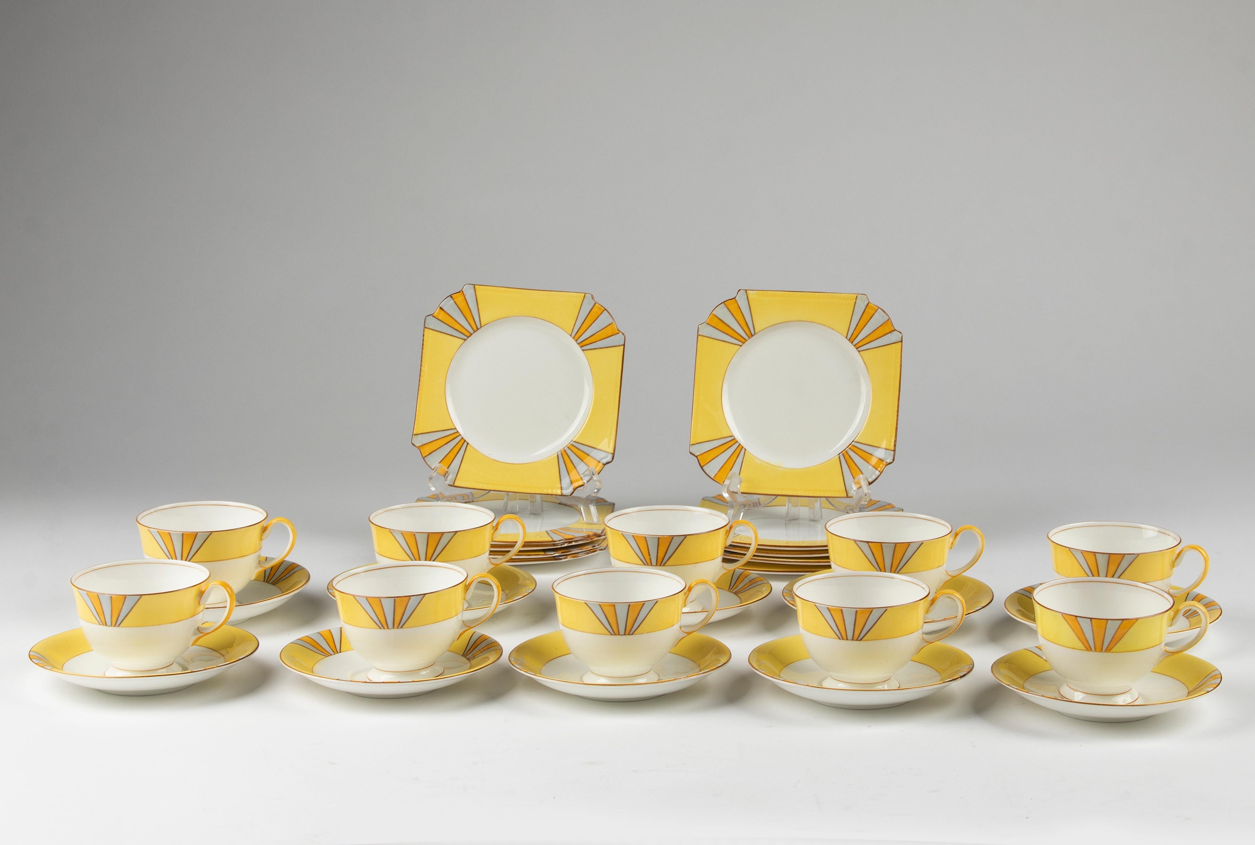 A lovely set of 10 Art Deco tea trio's, made by the English brand Aynsley. Nicely square shaped cake plates, decorated with cheerful yellow colors. 
The cake plates are 15 x 15 cm. The cups have quite a nice size, they are 6,5 cm tall and Ø8,5 cm.