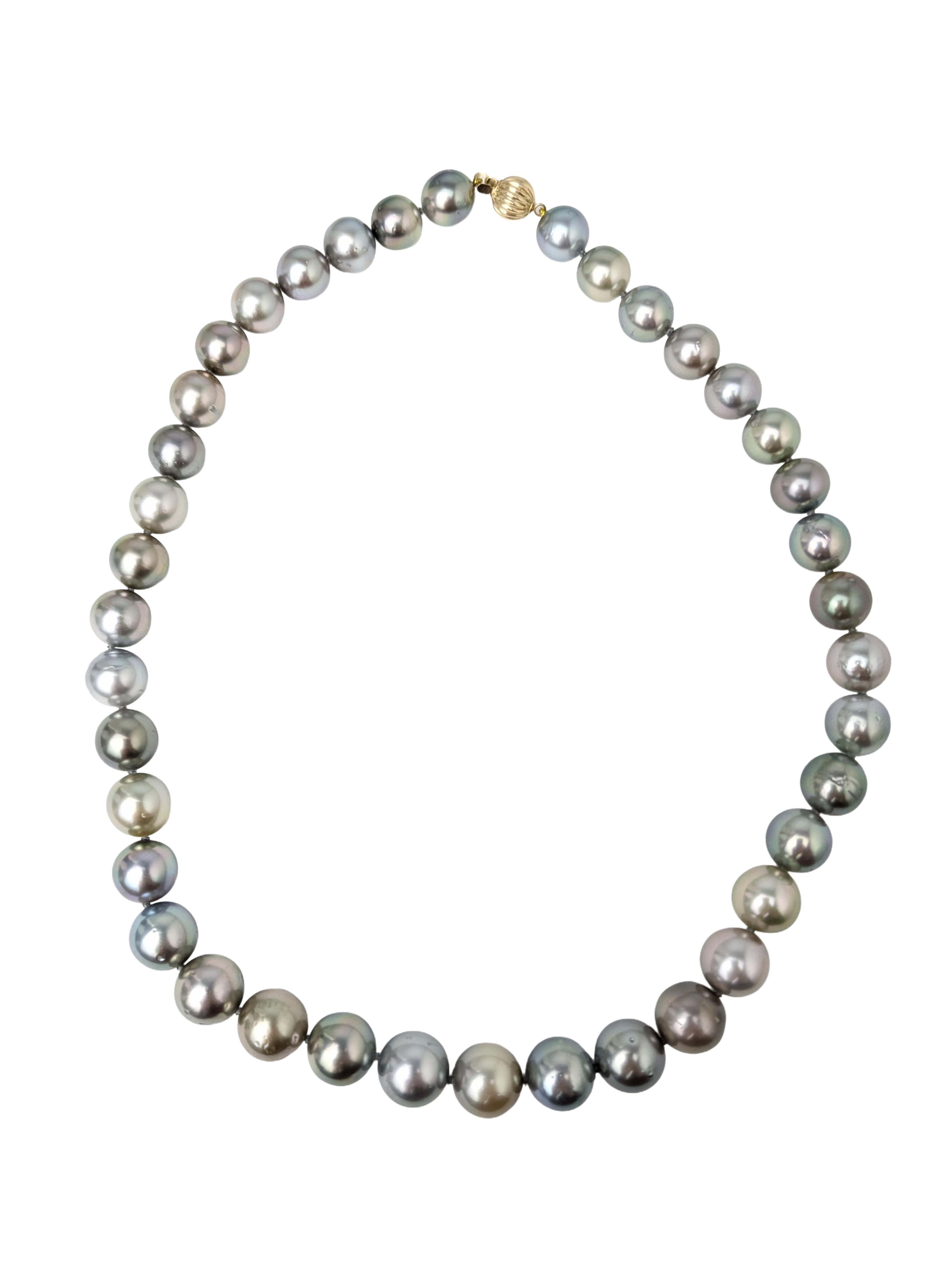 A timeless strand of natural elegance. This necklace features a stunning mix of grey Tahitian pearls, each hand-selected for its unique tone and luster. The round pearls are individually knotted for elegance and durability, showcasing a beautiful