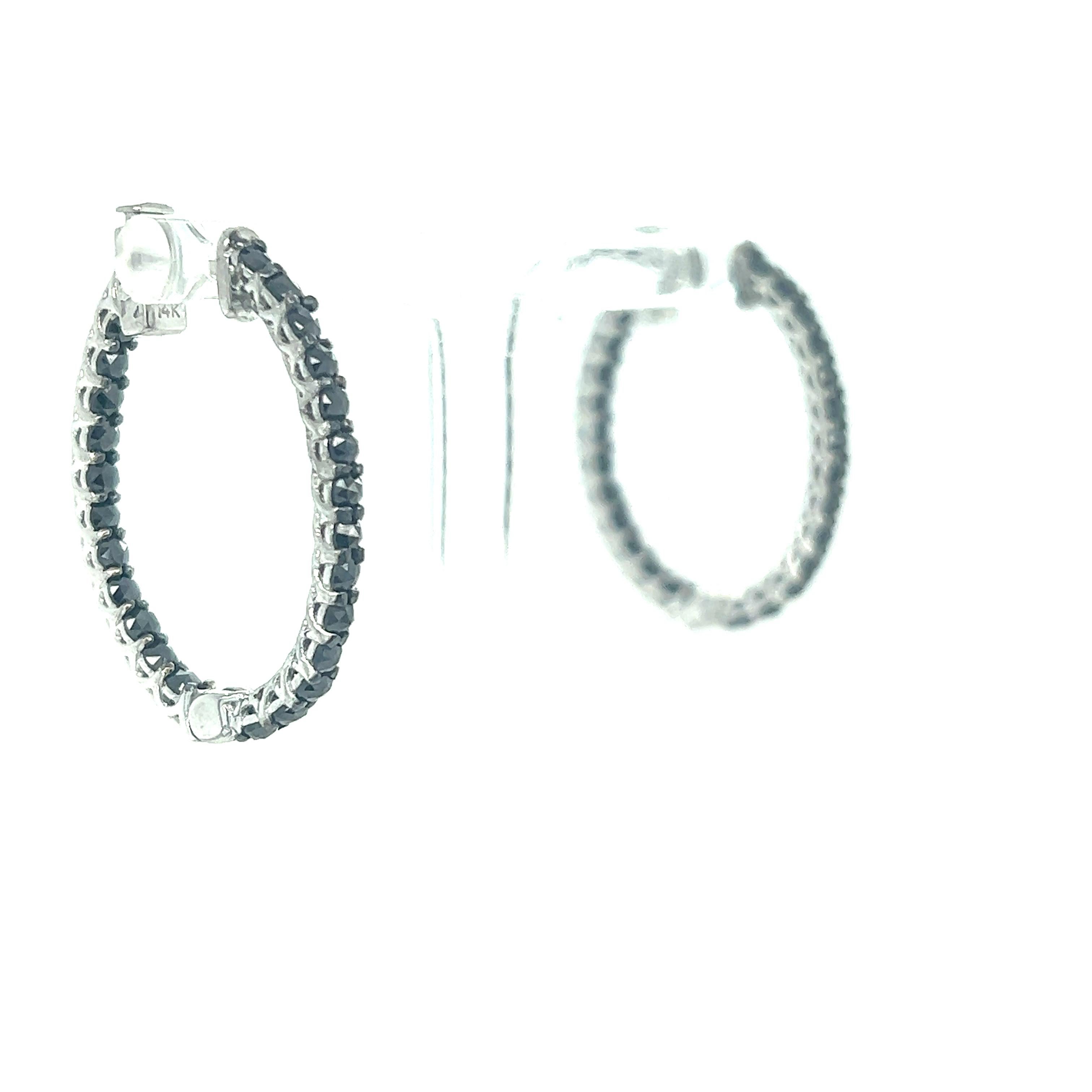 These hoop earrings have Natural Round Cut Black Diamonds that weigh 2.00 carats. 

They are set in 14 Karat White Gold and have an approximate gold weight of 7.0 grams.

The hoops are 2.5 cm wide and 3 cm long. 