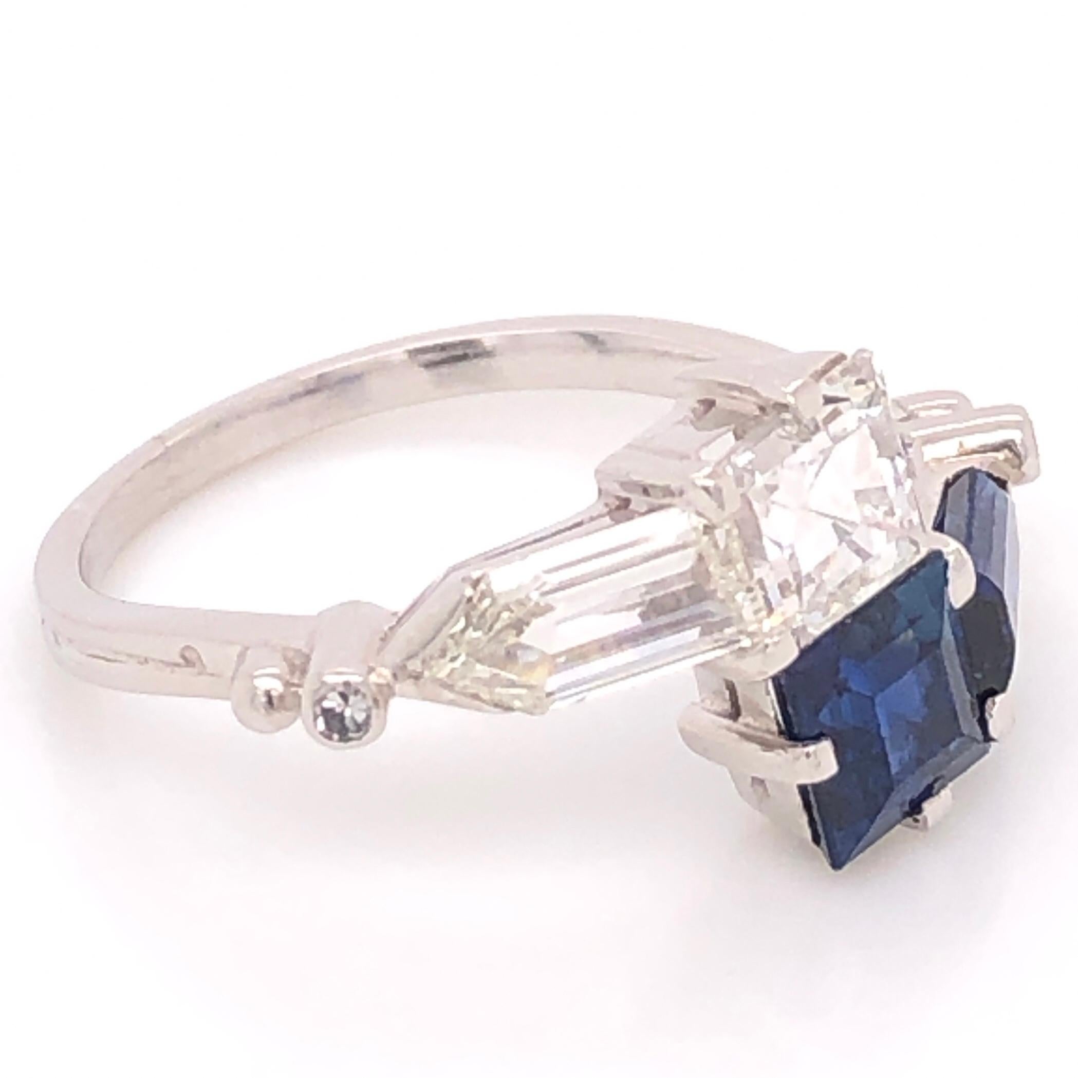 Classic and finely detailed Bypass Ring securely set with Blue Sapphires weighing approx. 2.00 Carat total weight and Diamonds, weighing approx. 0.96 and 0.72 carats. Hand crafted Platinum mounting. Ring size 8, resizing available. This Simple and