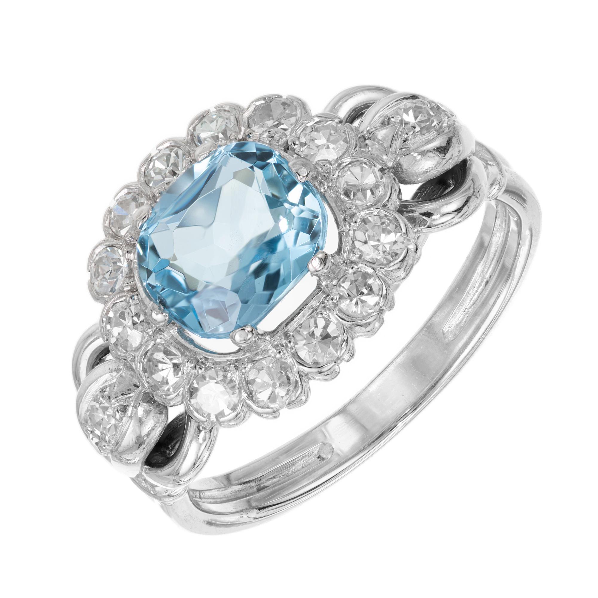 1940's Zircon and diamond engagement ring. 2.00 carat rich blue cushion shape center blue zircon in a 14k white gold setting with a halo of round single cut open bezel set diamonds. Also accented with a round single cut diamond on each side. 

1