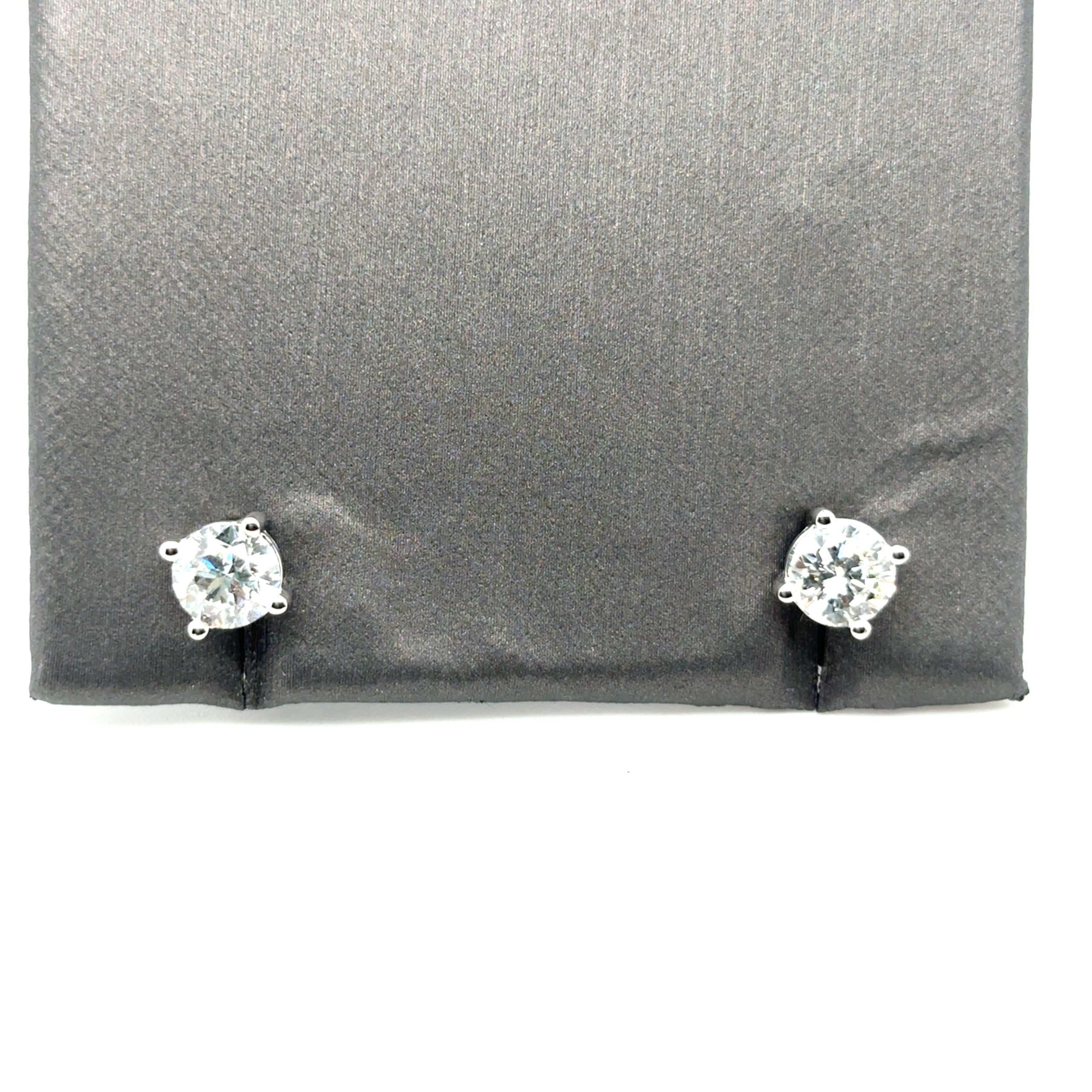 Boucles d'oreilles compos�ées de diamants ronds de taille brillant de 2,00 carats, assortis de manière experte et sertis dans des montures panier classiques à quatre branches avec des dos à vis sécurisés. Réalisés en or blanc 14 carats, ces clous