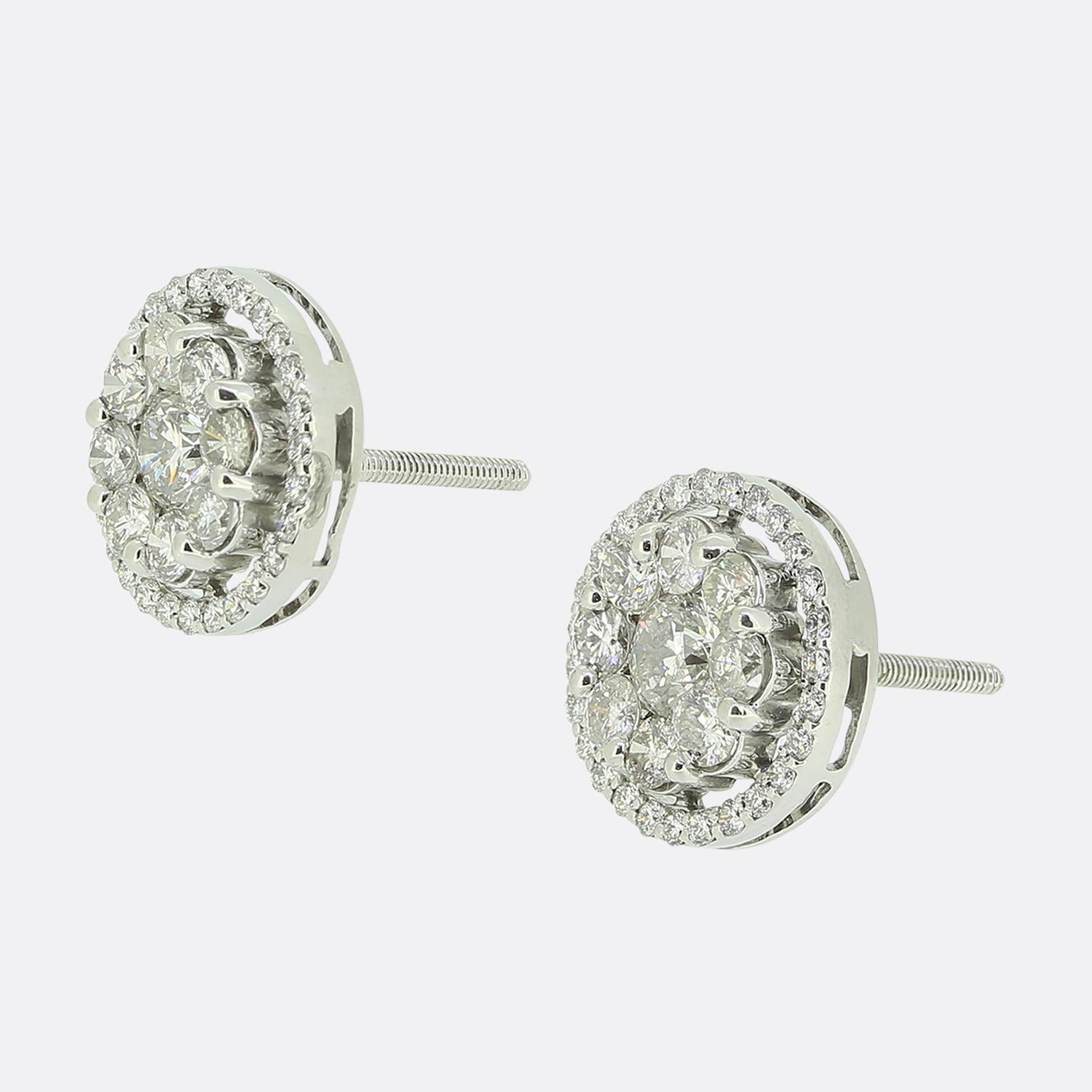 Here we have a lovely pair of diamond cluster earrings. Each identical piece has crafted from 14ct white gold and features a 0.28ct round brilliant cut diamond at the centre surrounded by a border of slightly smaller matching stones. This focal
